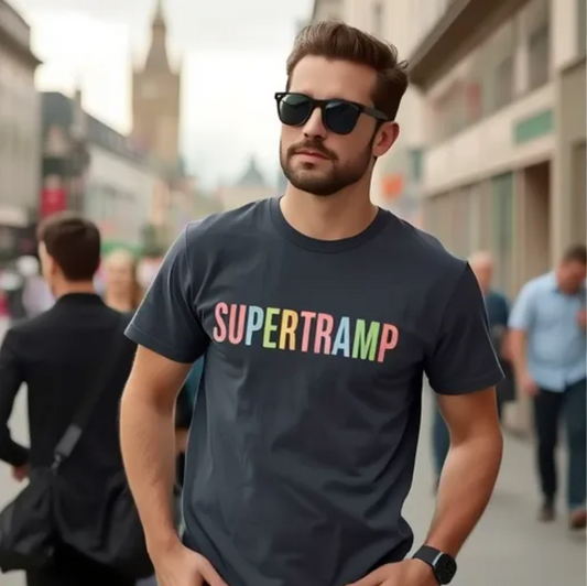 Man wearing a dark gray Supertramp t-shirt with a colorful retro logo, standing confidently on a city street in sunglasses.