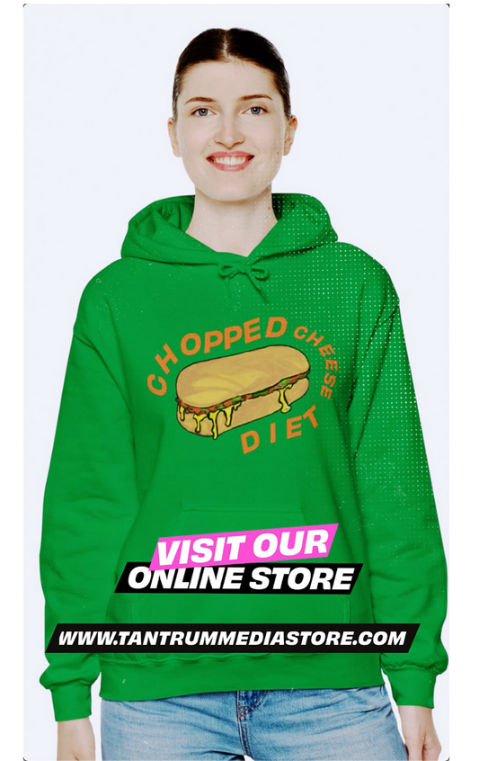 A smiling woman wearing a green hoodie with a graphic of a chopped cheese sandwich and the words "CHOPPED CHEESE DIET." The hoodie is from tantrummediastore.com