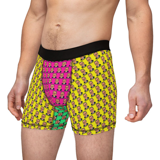 Male model wearing Chuck Schumer boxer briefs with colorful face print pattern and black waistband, front-side view