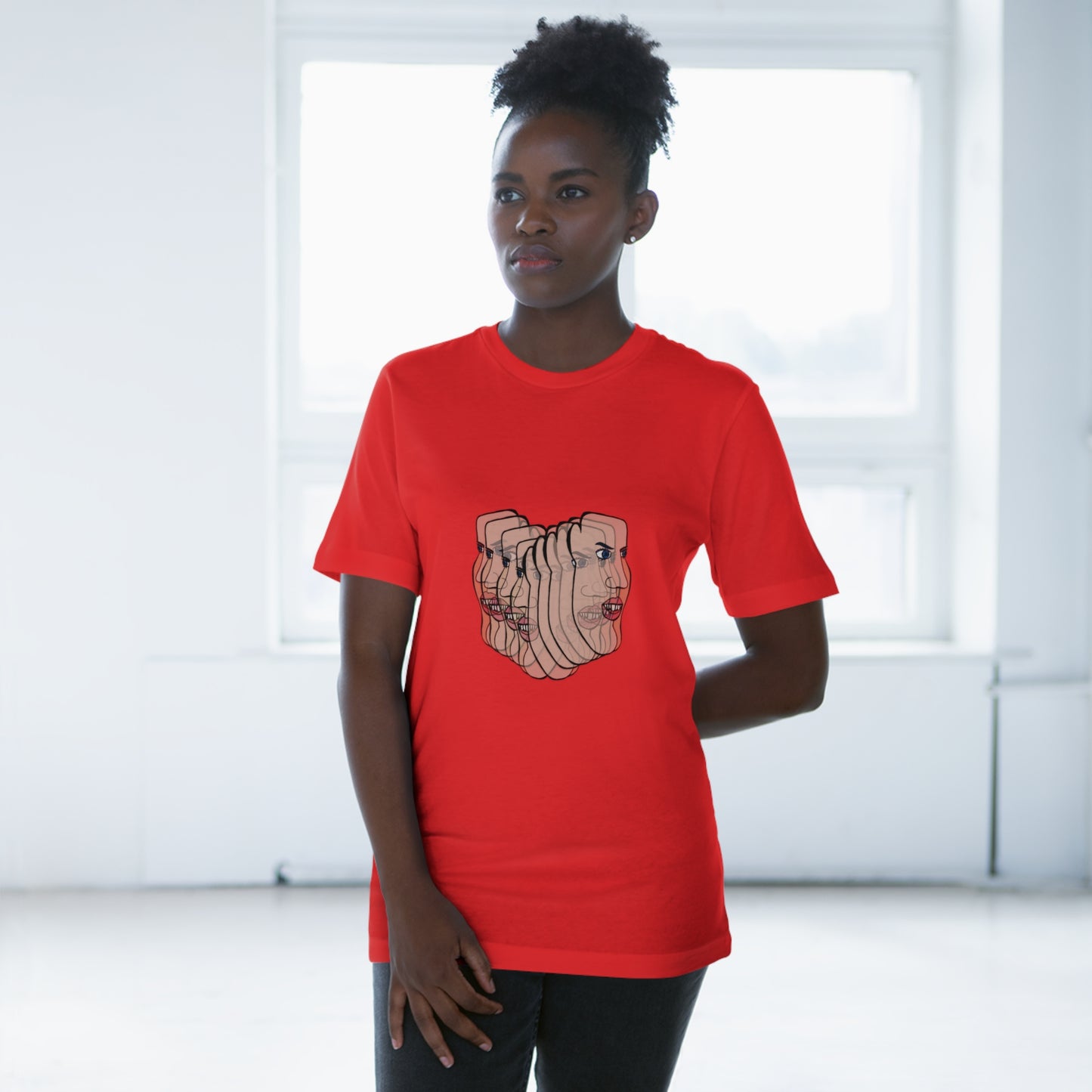 Female model in red Charlie t-shirt with afro, standing in soft lighting indoors