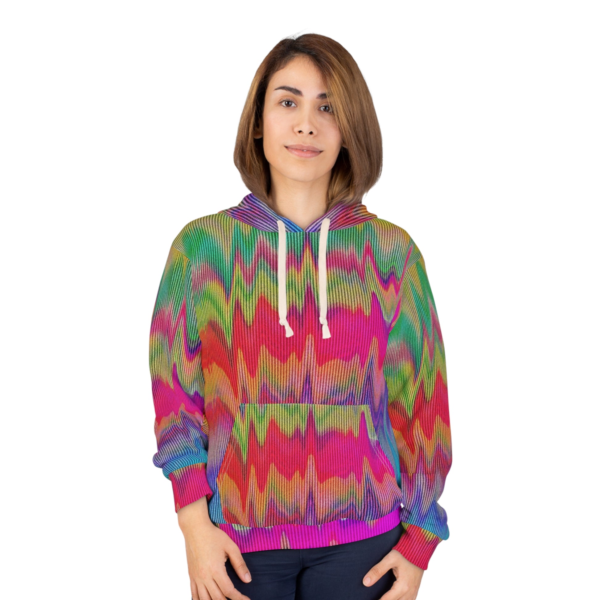 Model wearing a vibrant unisex hoodie featuring an all-over psychedelic glitch pattern in neon pink, green, yellow, and blue with a front pocket and white drawstrings