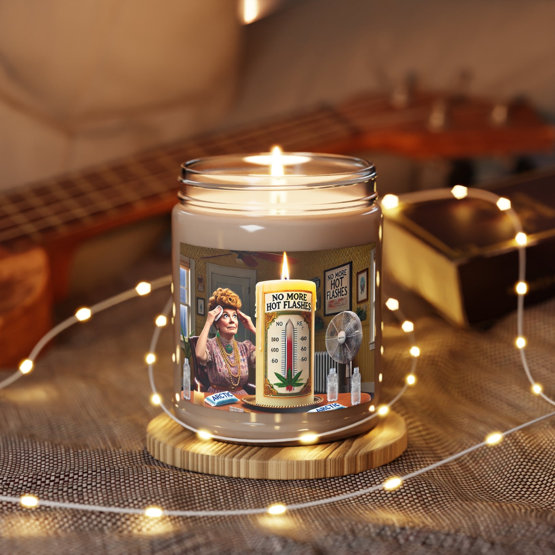 A white soy wax candle in a clear glass vessel with a vintage label featuring illustrations of a distressed woman, fans, ice packs, and a lit candle.