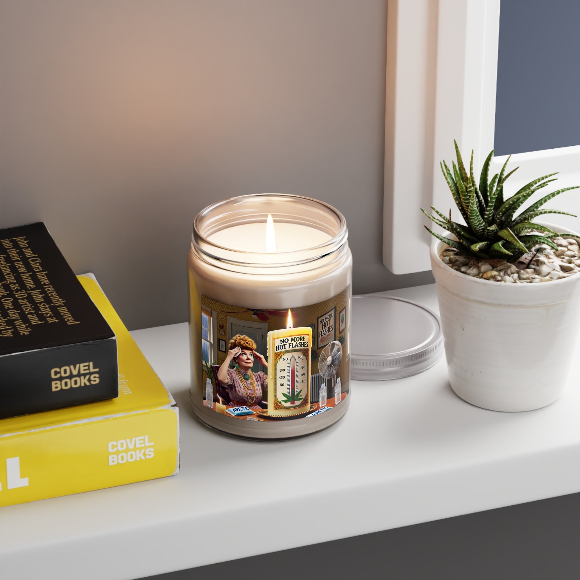 A white soy wax candle in a clear glass vessel with a vintage label featuring illustrations of a distressed woman, fans, ice packs, and a lit candle.