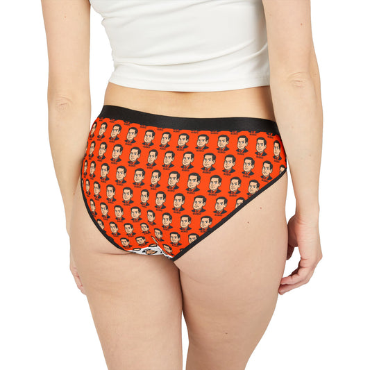 Model wearing orange Marco Rubio face print panties with black trim, back view