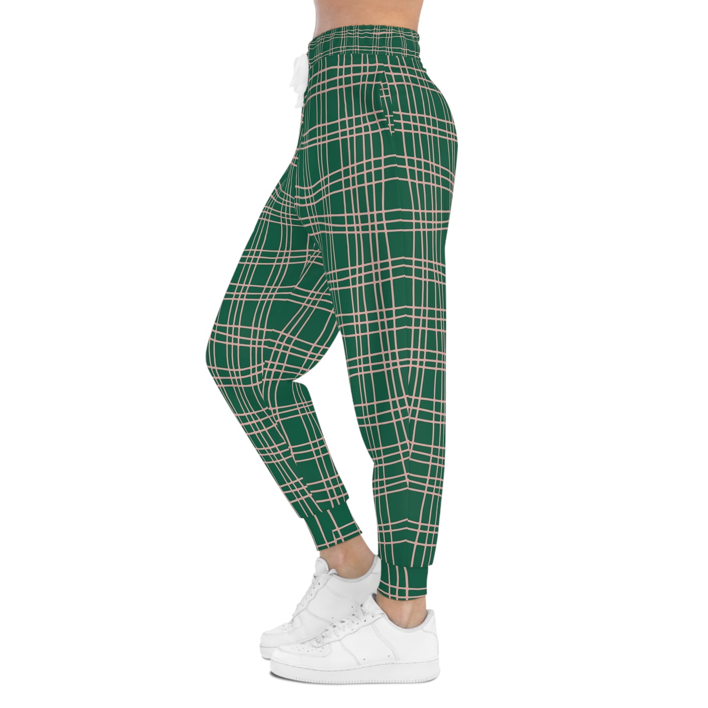 Female model wearing Green Plaid Joggers side profile, highlighting slim tapered legs and plaid pattern.