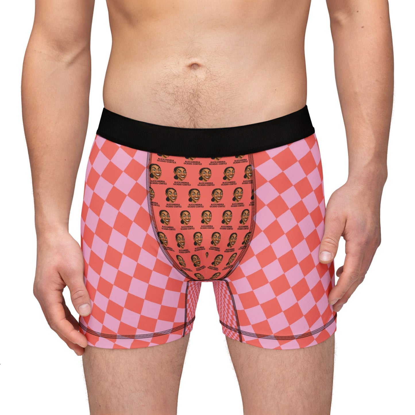 Zoomed-in front view of model wearing AOC-themed checkered boxer briefs with novelty face print.