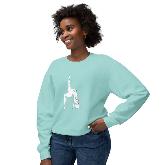 Smiling woman wearing a turquoise-colored unisex crewneck sweatshirt featuring a hand-drawn illustration of a flexible cartoon girl in a split pose.