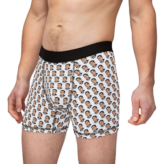 Male model wearing white boxer briefs with all-over Marco Rubio face print and black waistband, front-side angle