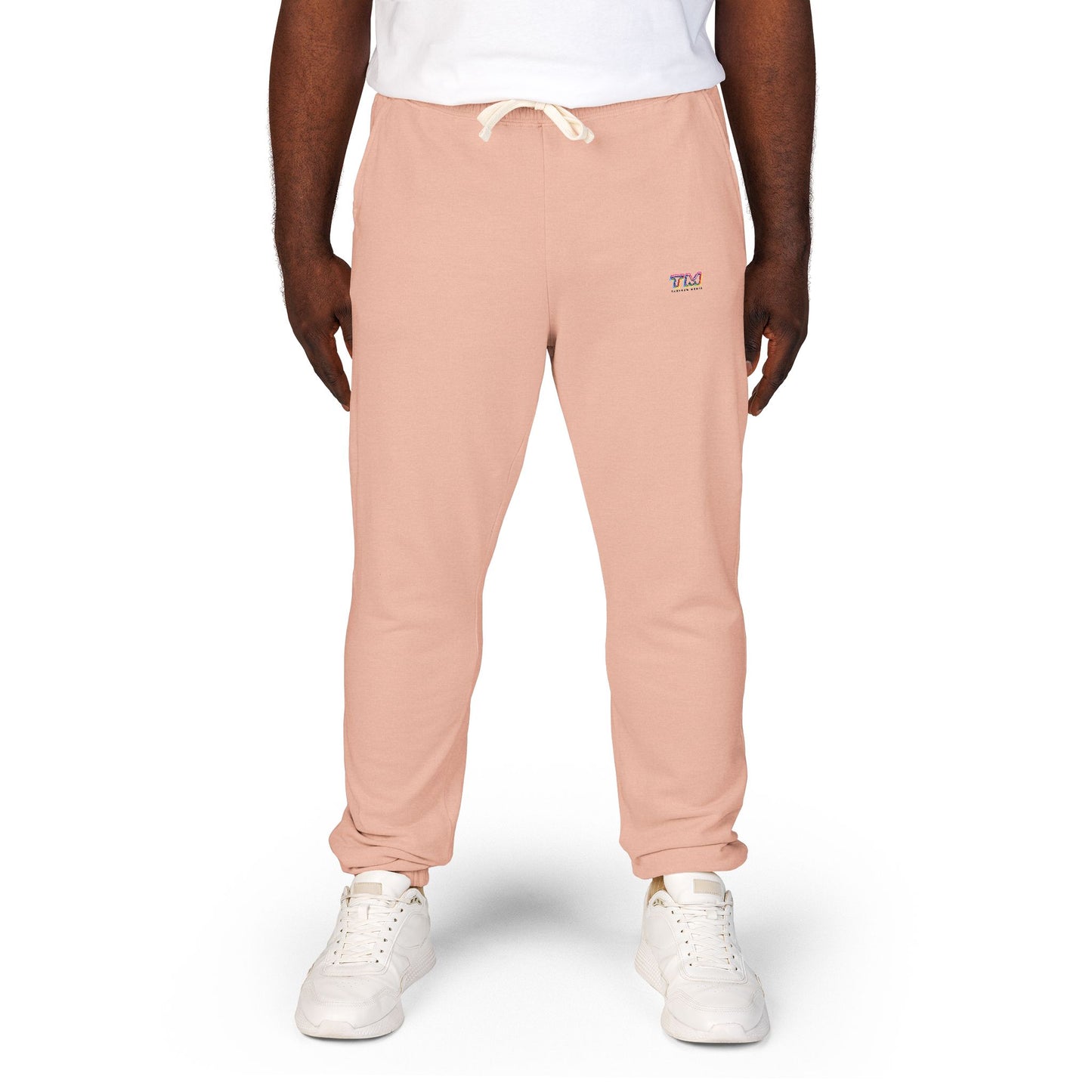 Male model wearing pink Tantrum Media Sweatpants with TM logo near pocket