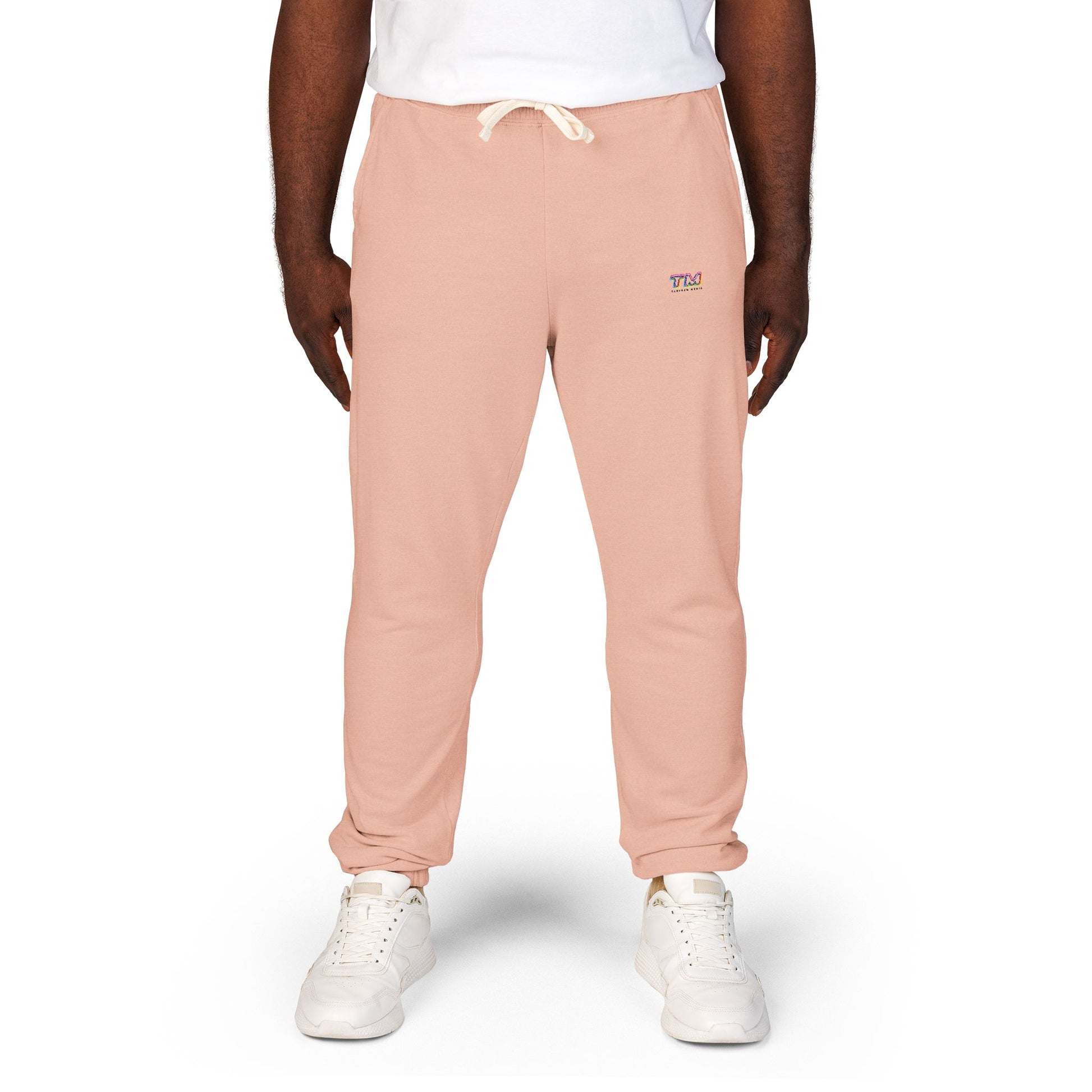 Male model wearing pink Tantrum Media Sweatpants with TM logo near pocket