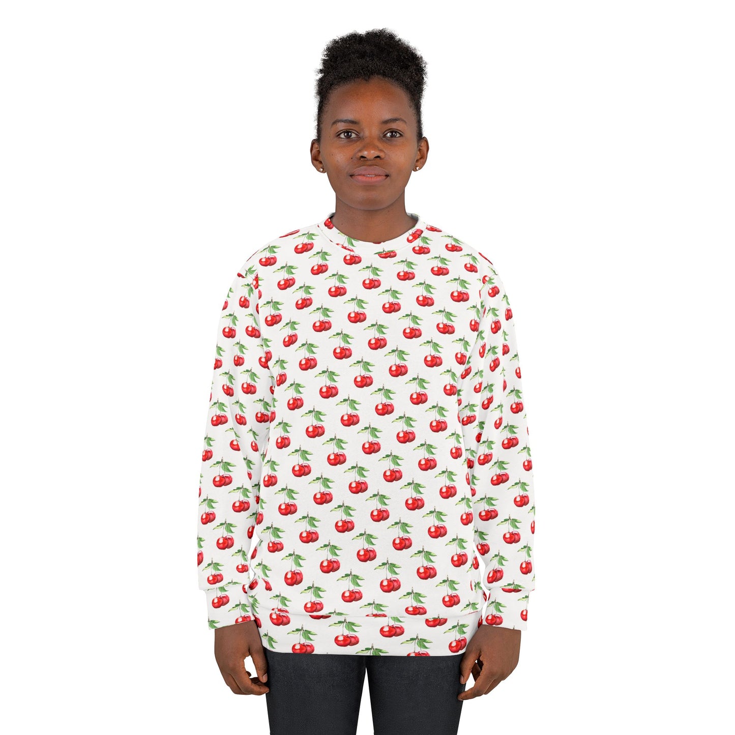 Model wearing a white unisex sweatshirt with a vibrant all-over cherry print, featuring red cherries with green stems.