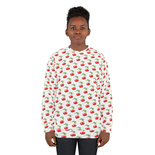 Model wearing a white unisex sweatshirt with a vibrant all-over cherry print, featuring red cherries with green stems.