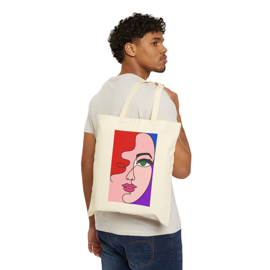 Man carrying a natural canvas tote bag featuring a colorful abstract face line-art design