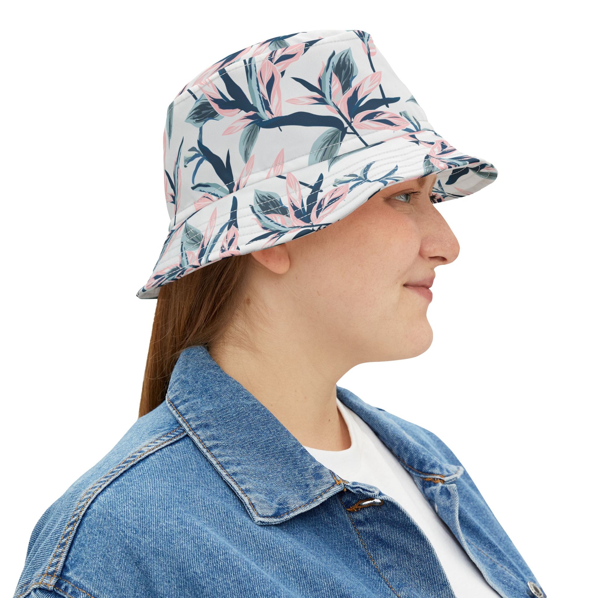 Woman wearing floral bucket hat with watercolor blossoms, side profile smiling.