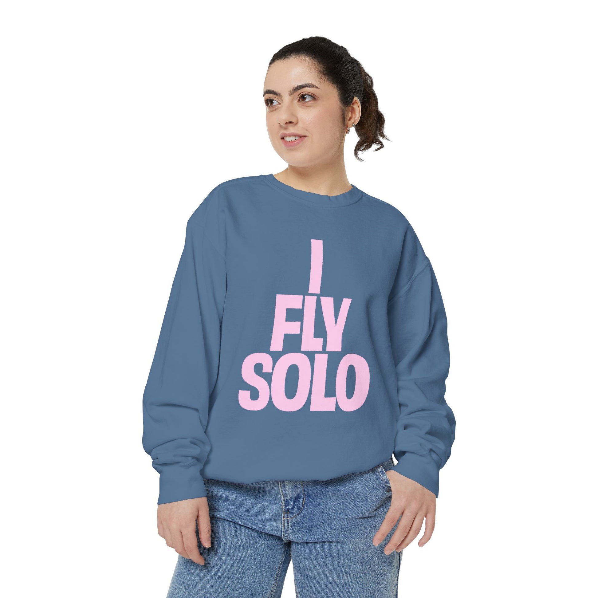 Woman wearing a blue sweatshirt with 'I Fly Solo' text on a white background