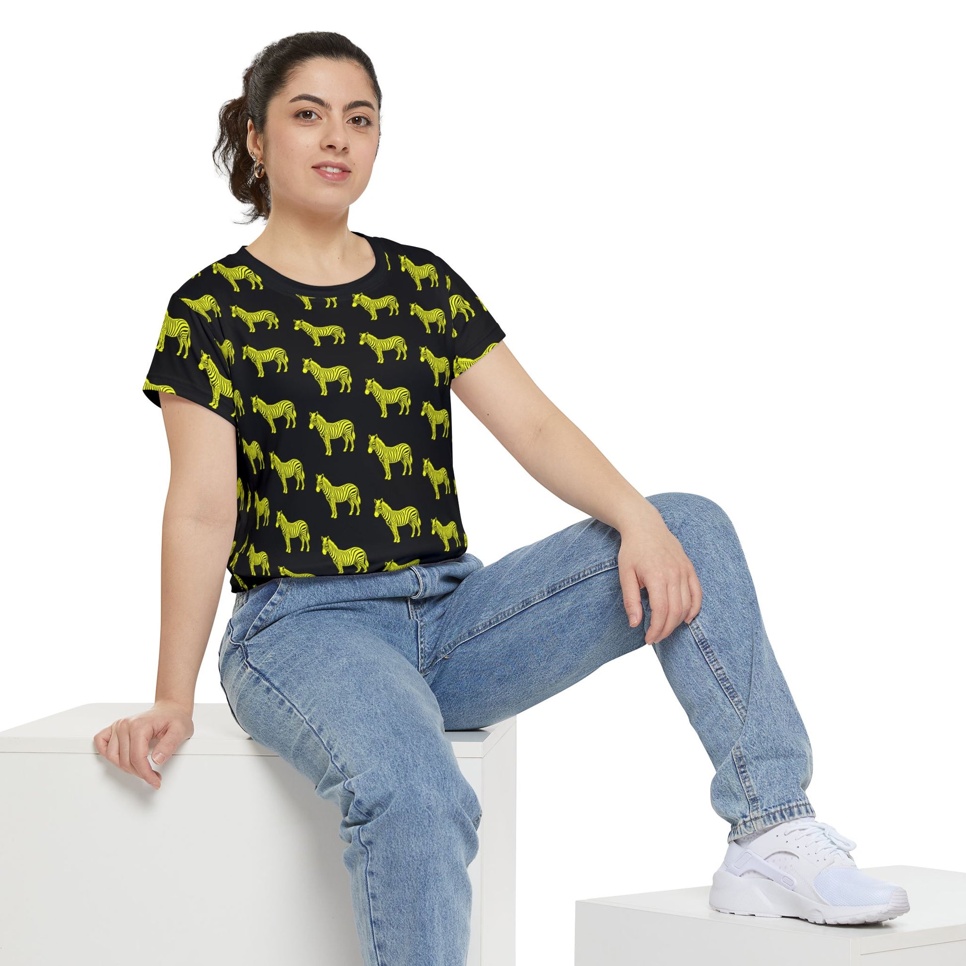 Close-up of woman wearing Yellow Zebra Women's T-Shirt with neon zebra print on black background.