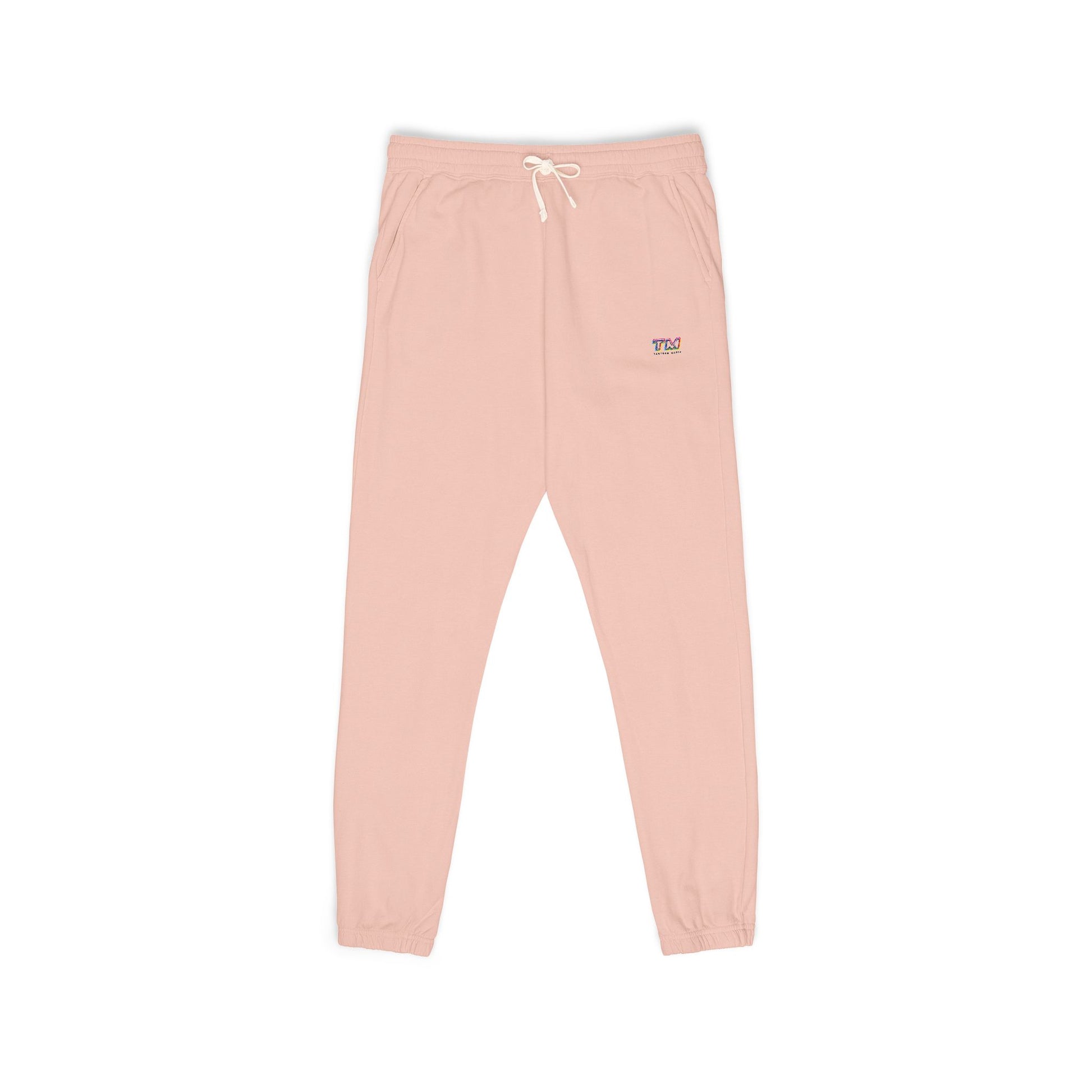 Peach sweatpants with a small Tantrum Media logo on a white background