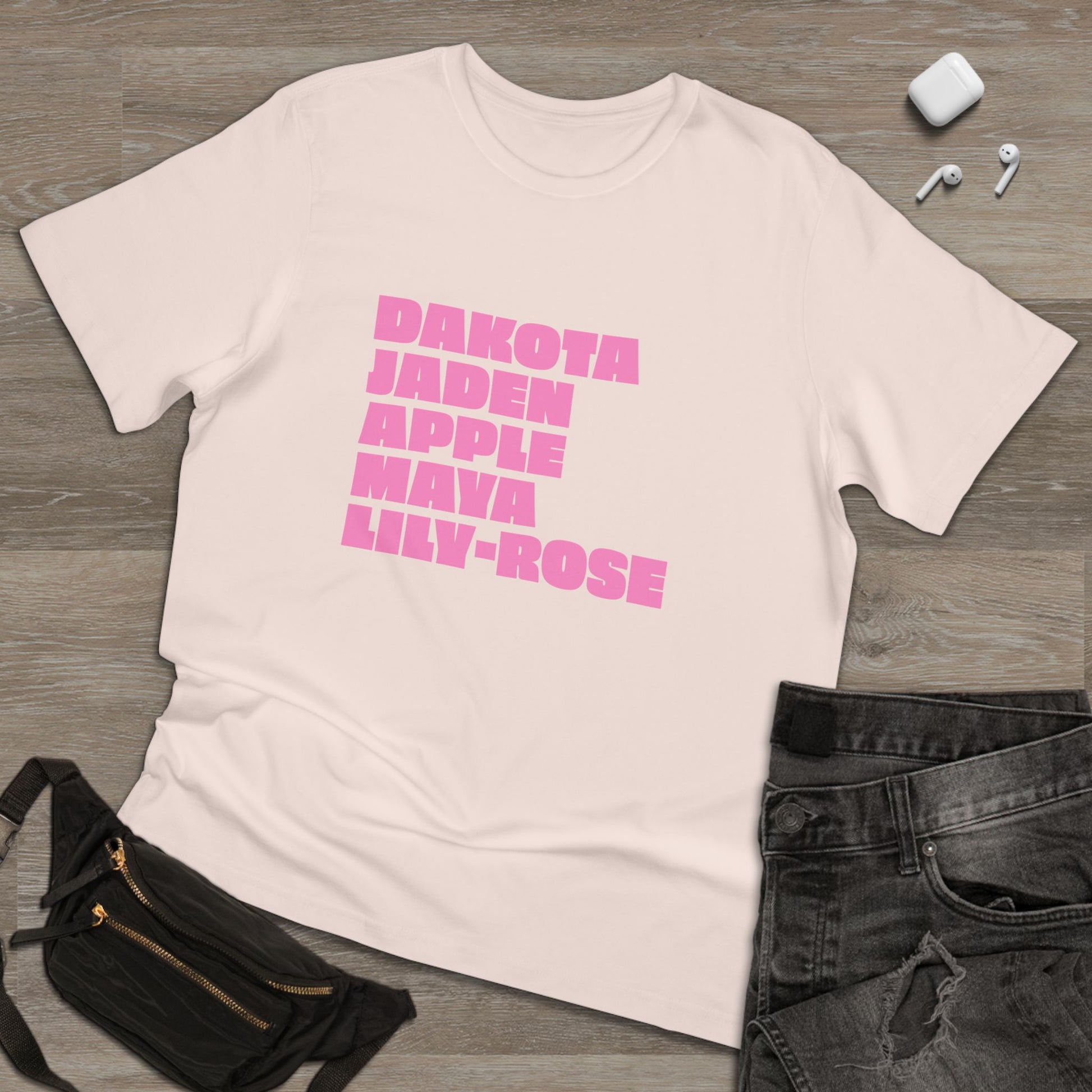 Pale pink Nepo Babies List T-Shirt with pink lettering flat lay