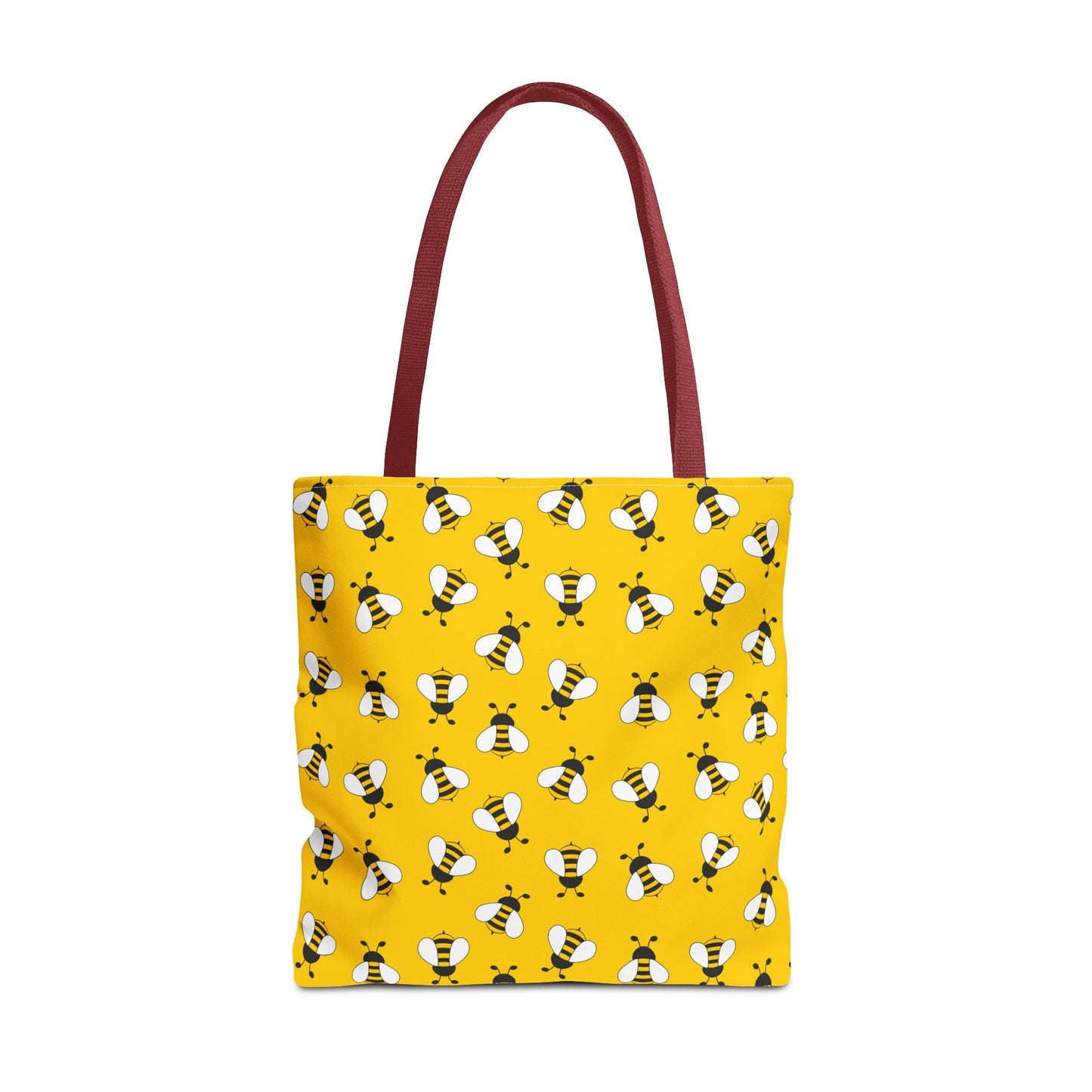Yellow tote bag with bee pattern and red handle on a white background