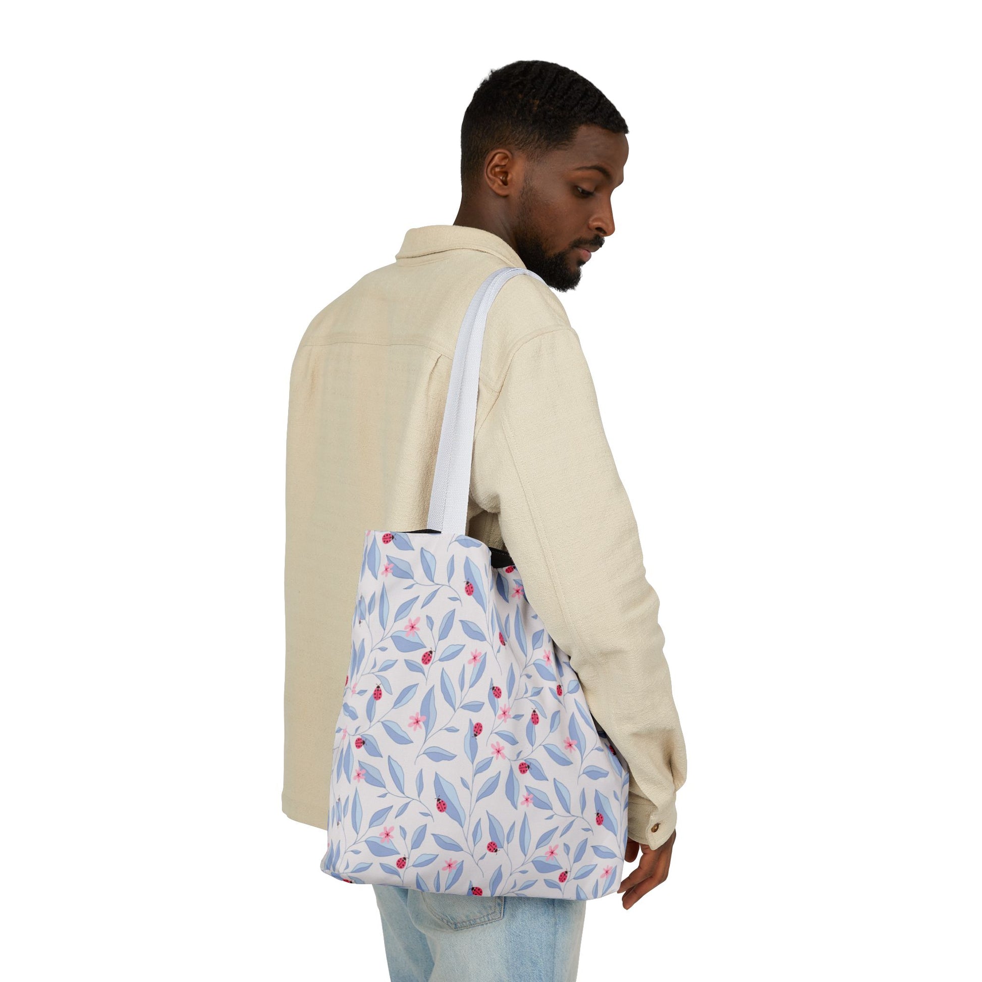 Man seen from behind carrying the Lady Bug Garden Tote Bag.