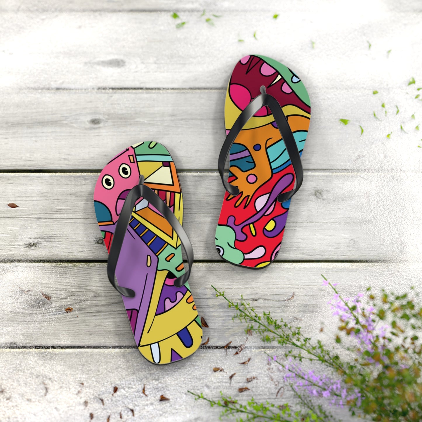Colorful graphic flip flops bold design urban streetwear footwear on a wooden deck.