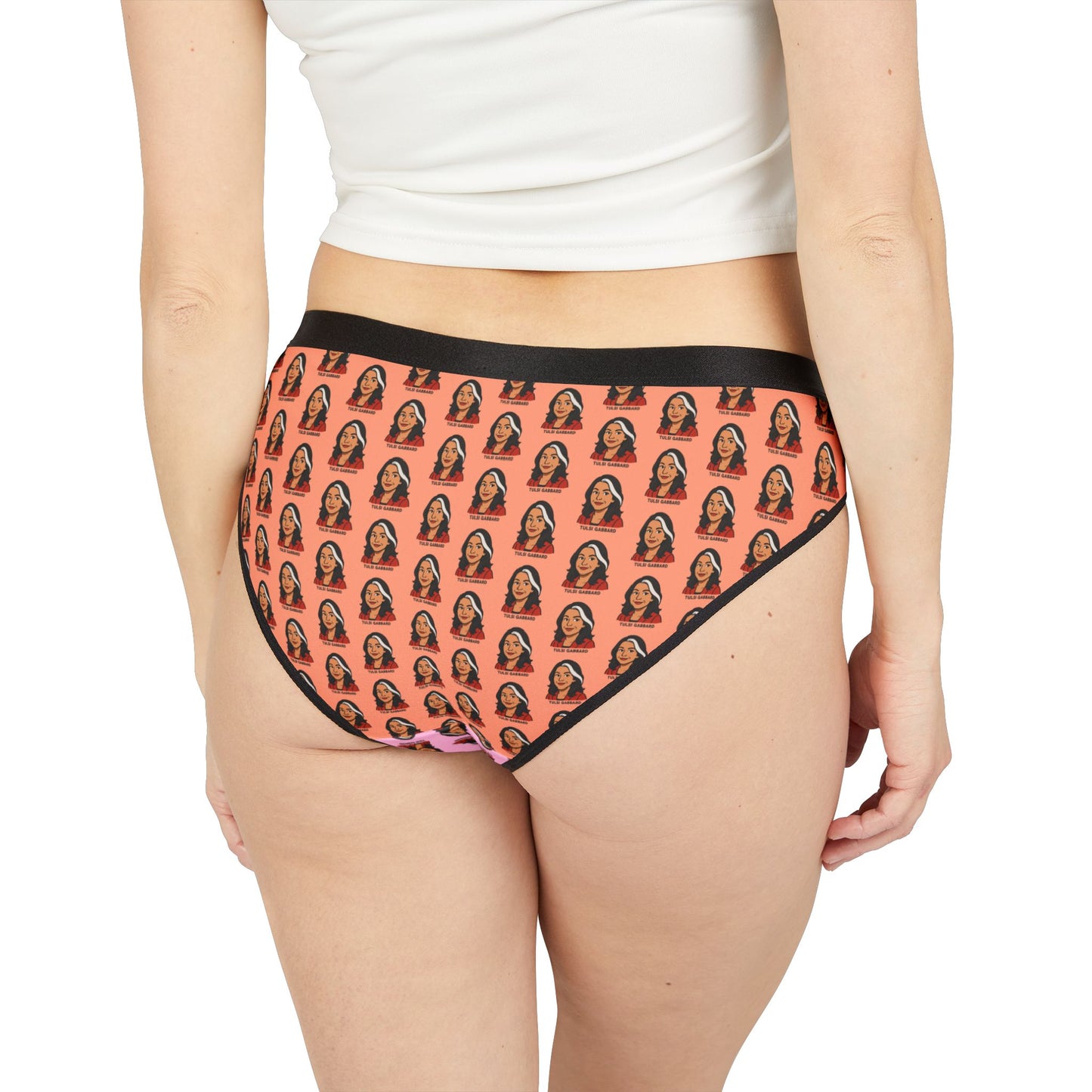 Model back view showing Tulsi Gabbard underwear with full face print on orange background and black waistband