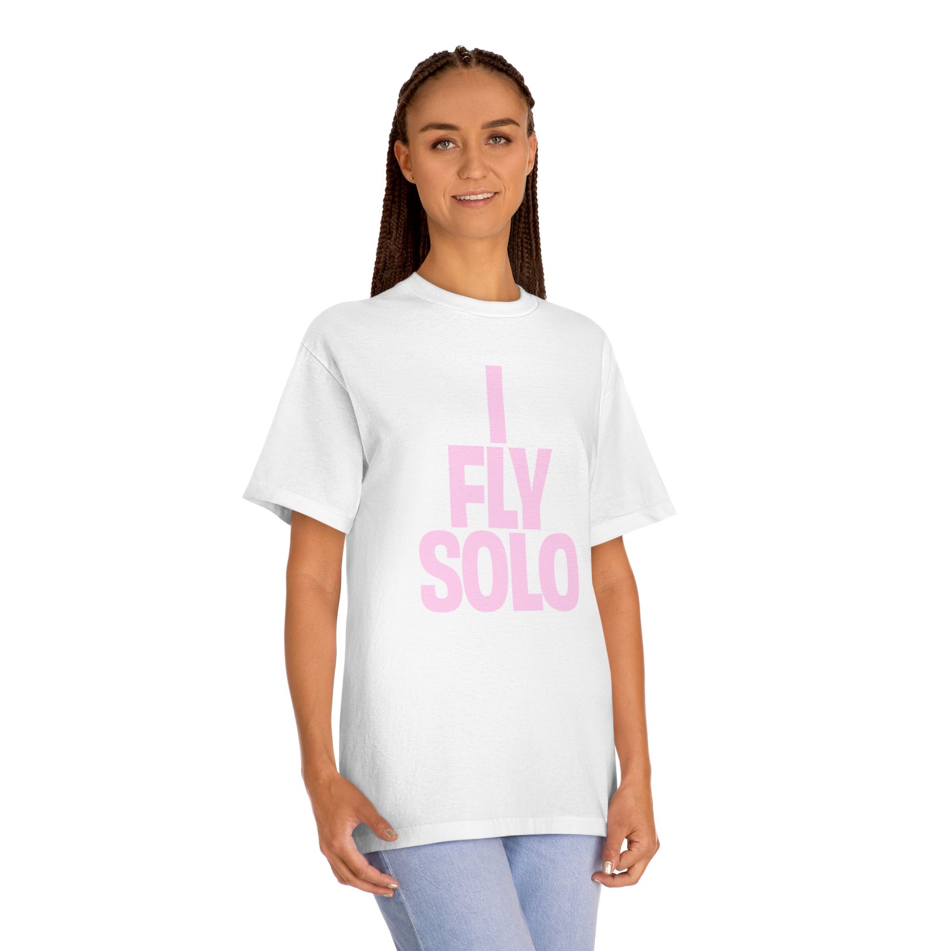 Person wearing a white t-shirt with 'I Fly Solo' in pink text on a white background