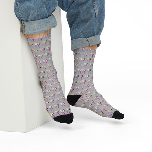Person wearing Lily & Matthew Streetwear Socks, sitting casually with rolled-up jeans, showcasing the illustrated pattern and black heel and toe design.