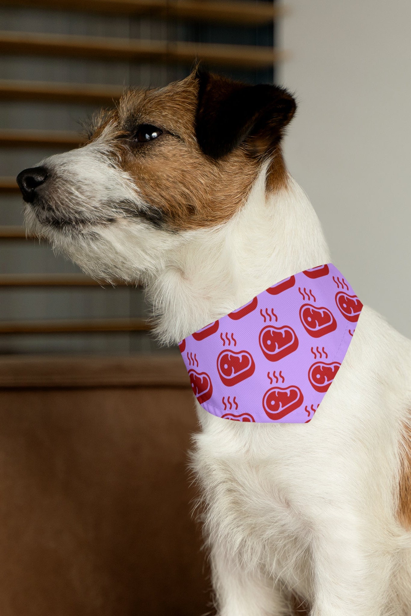 Dog wearing pink beef pattern bandana collar side profile