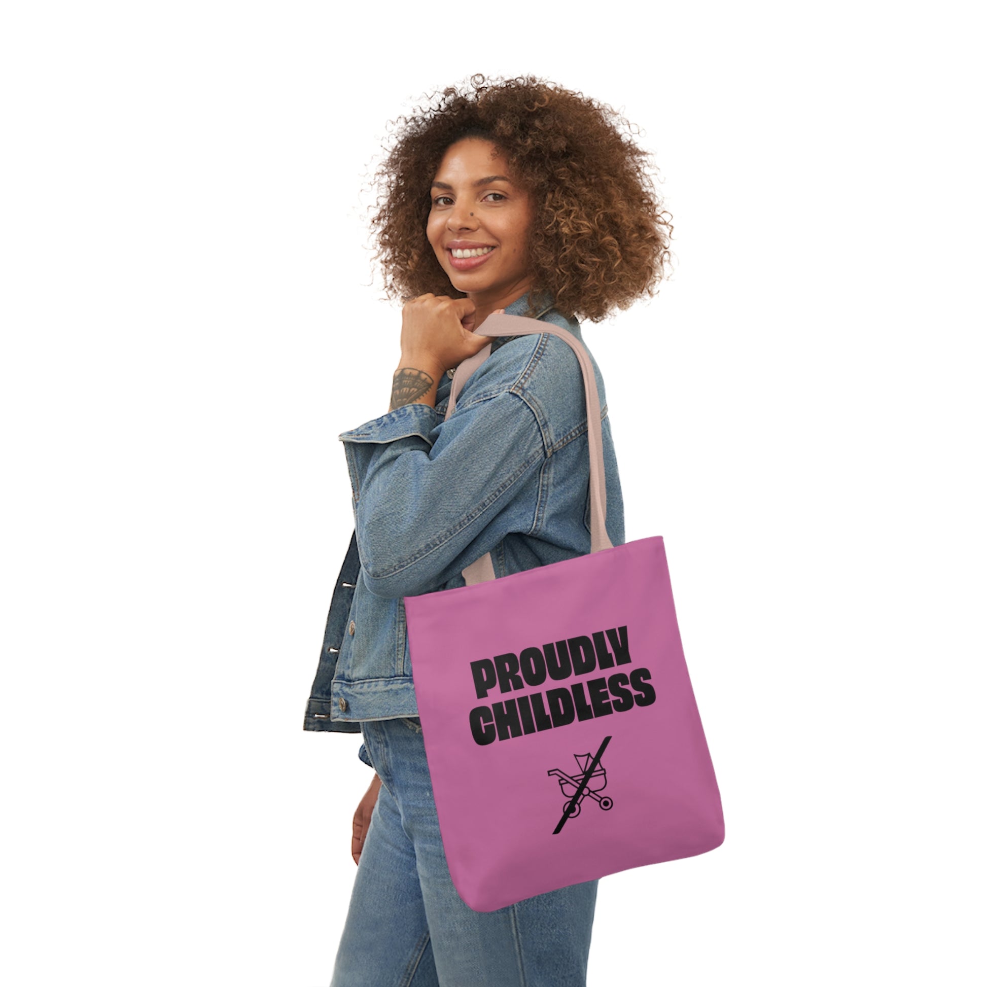 Woman carrying a tote bag featuring the text "Proudly Childless" with a crossed-out stroller symbol