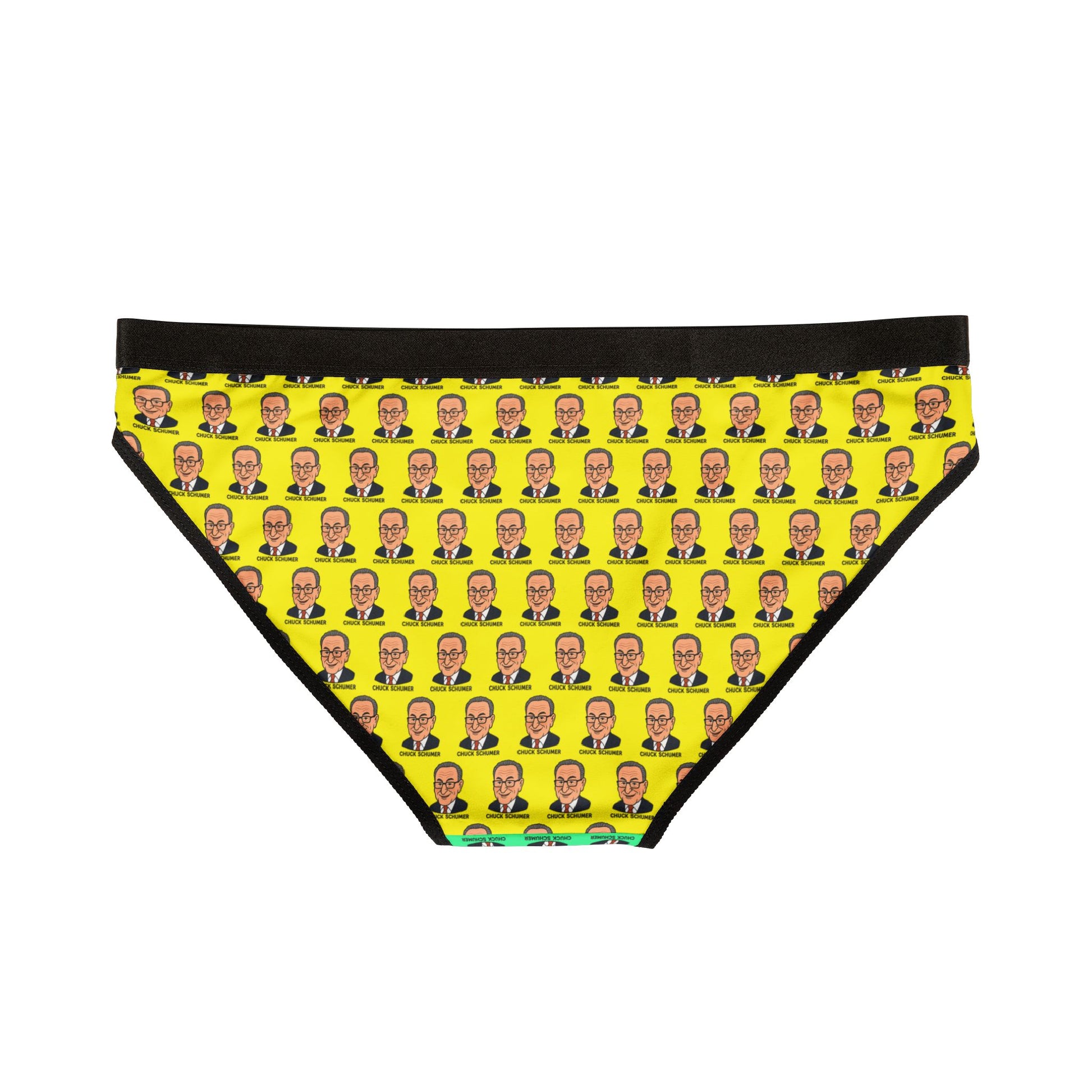 Flat lay back view of Chuck Schumer face print underwear with full yellow background and black waistband