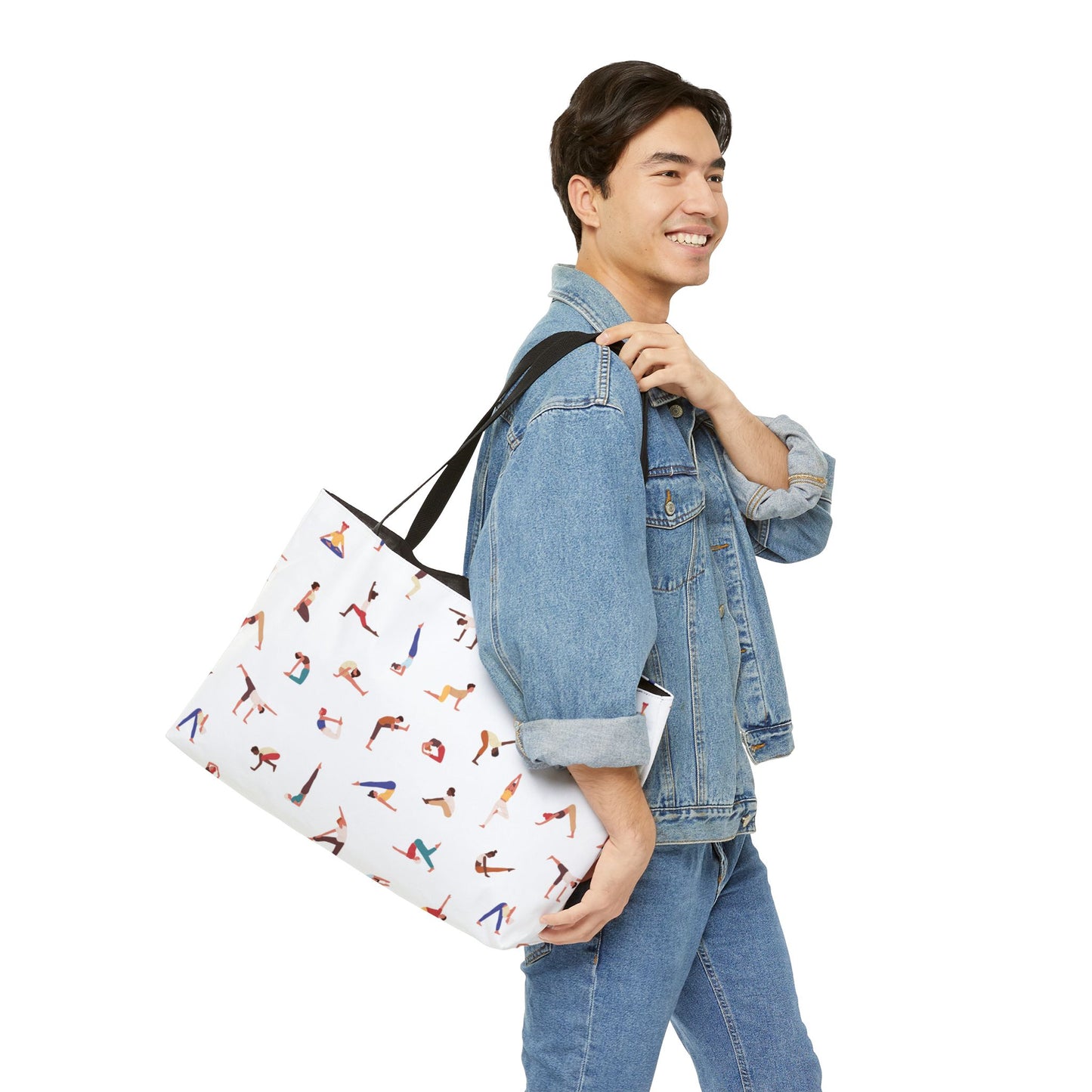 Man carrying a tote bag with colorful designs on a white background