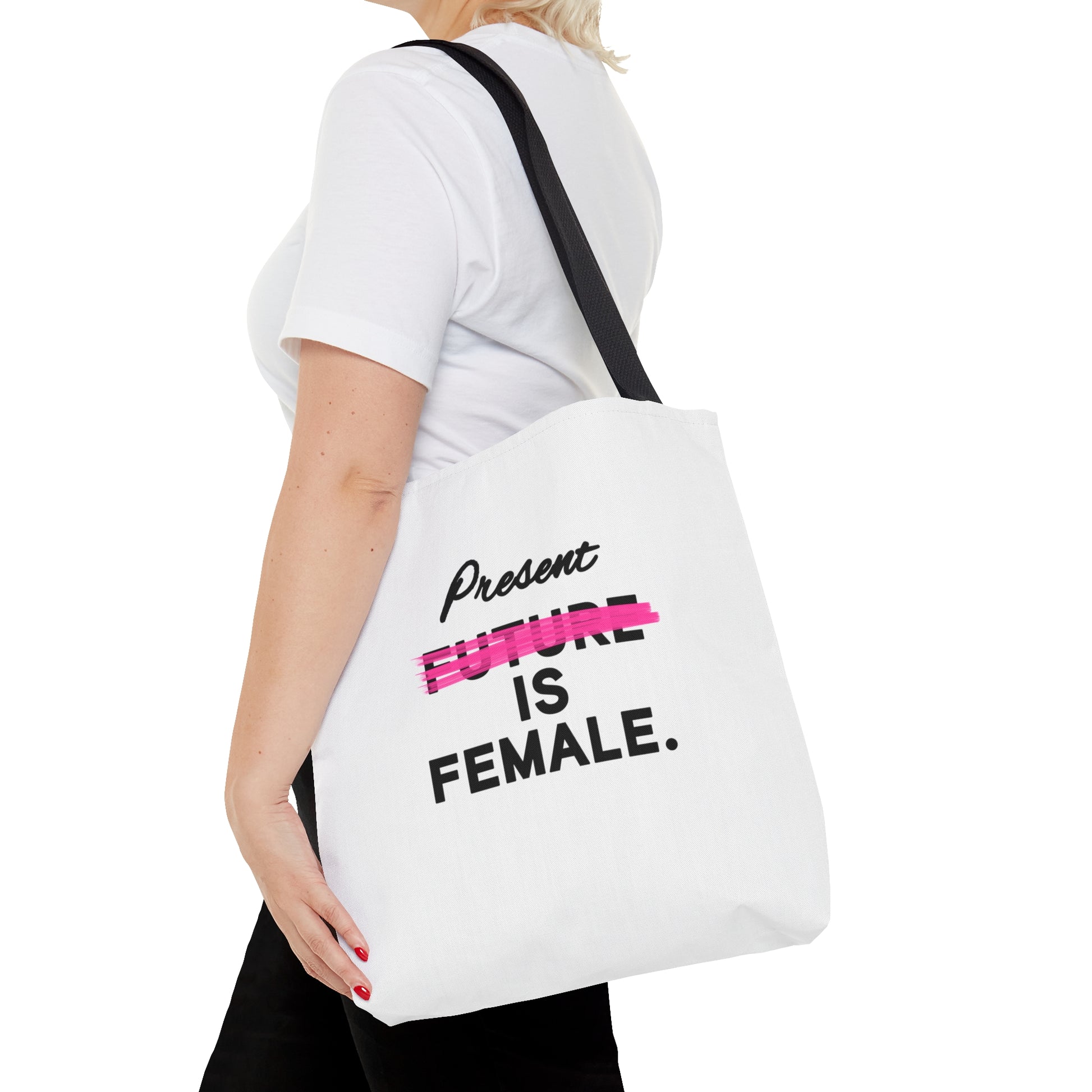 A white tote bag with the phrase "Present is Female" and "Future" crossed out in pink