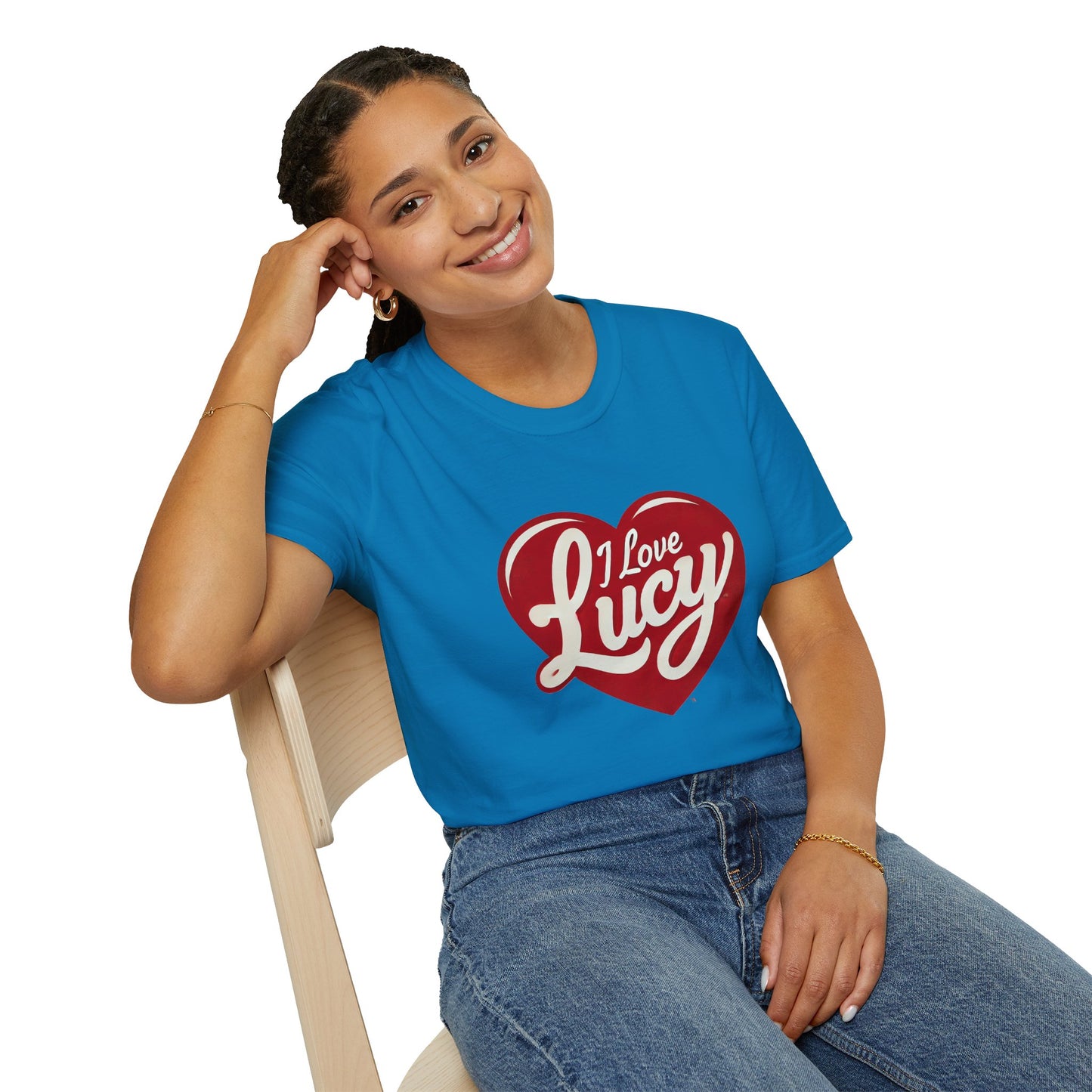 A young woman sitting, smiling, looking at camera wearing a vibrant blue "I love Lucy" T-shirt