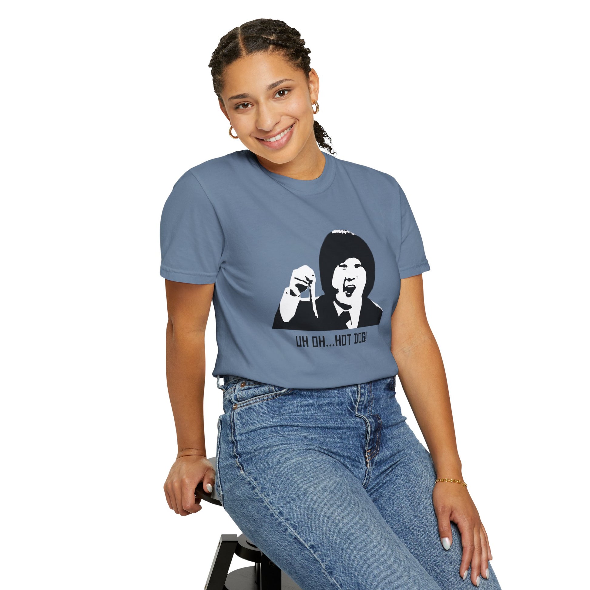 Woman modeling blue Uh Oh Hot Dog T-shirt, standing with hands in pockets.