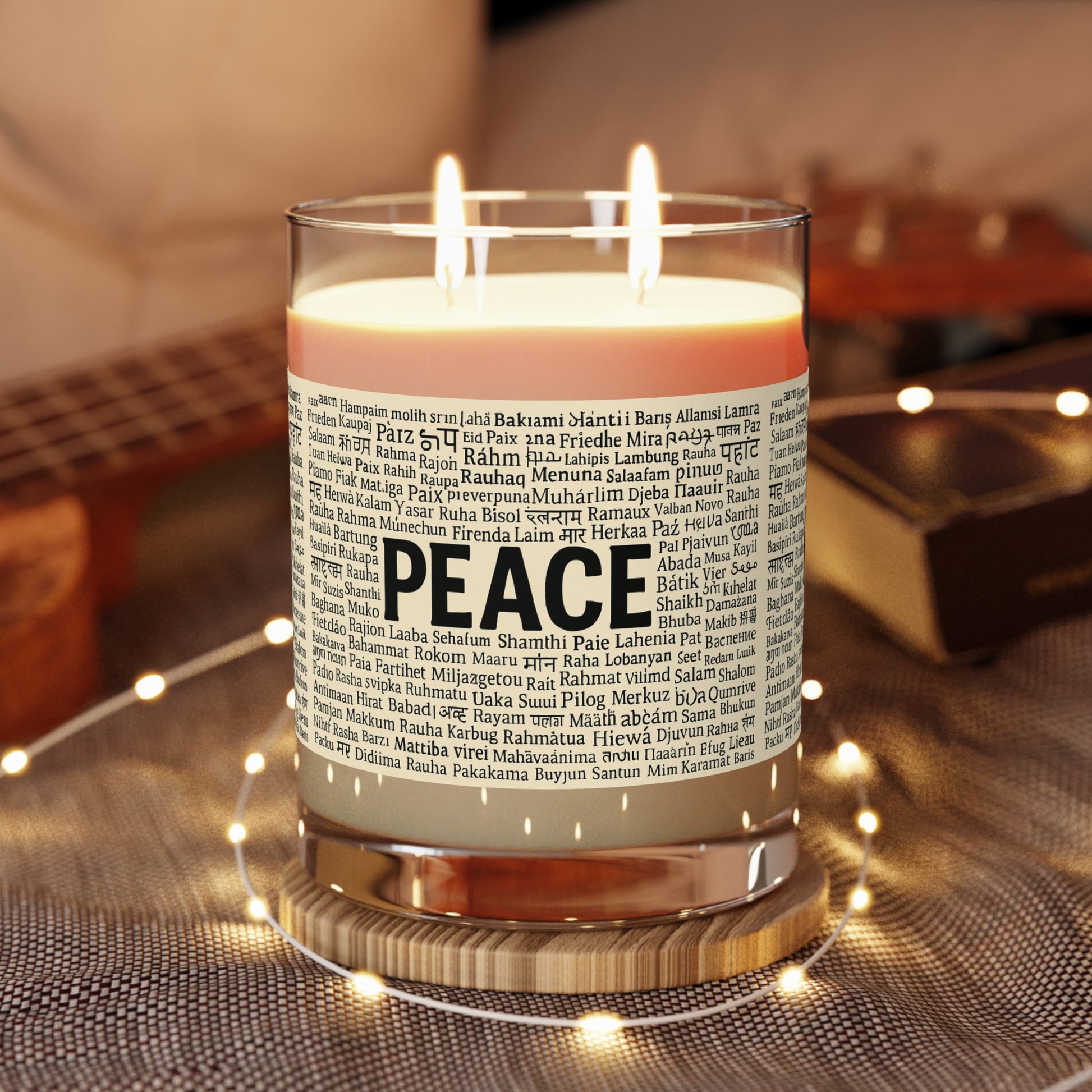 Candle with 'PEACE' label in a warm indoor setting