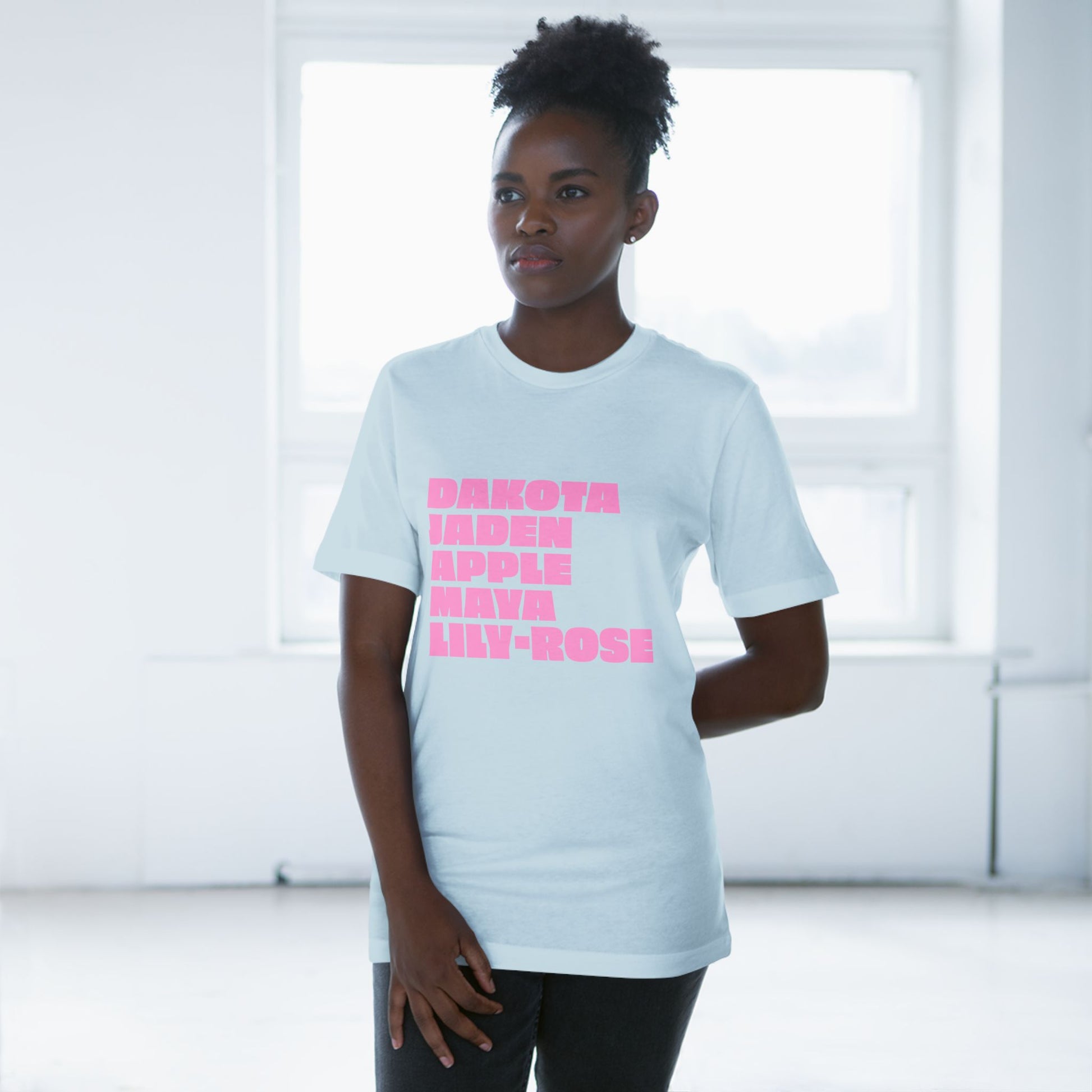 Light blue Nepo Babies List T-Shirt with pink lettering worn by female model