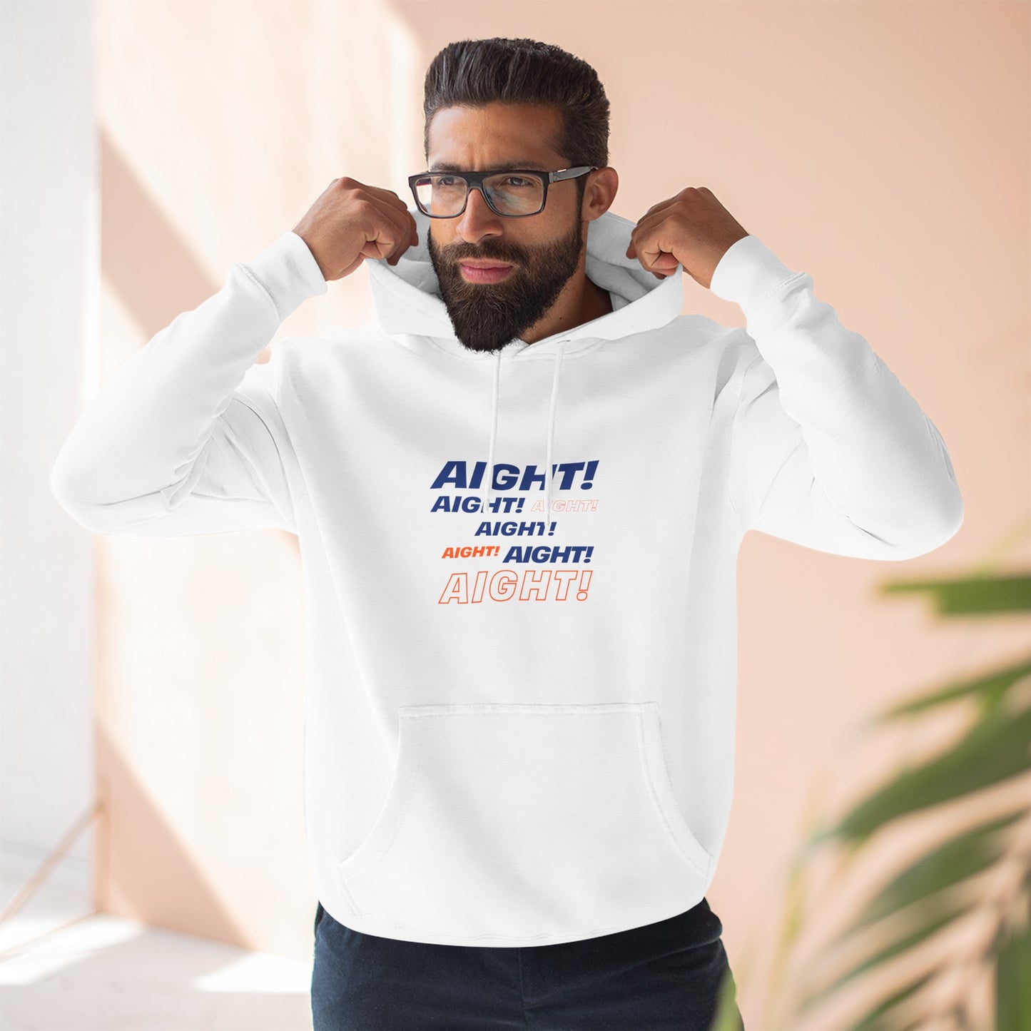 Man wearing white AIGHT hoodie from New Yorker collection with blue and orange text