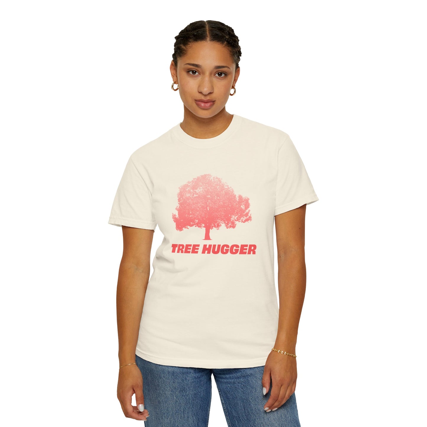 Woman standing wearing beige Tree Hugger T-shirt with red tree graphic