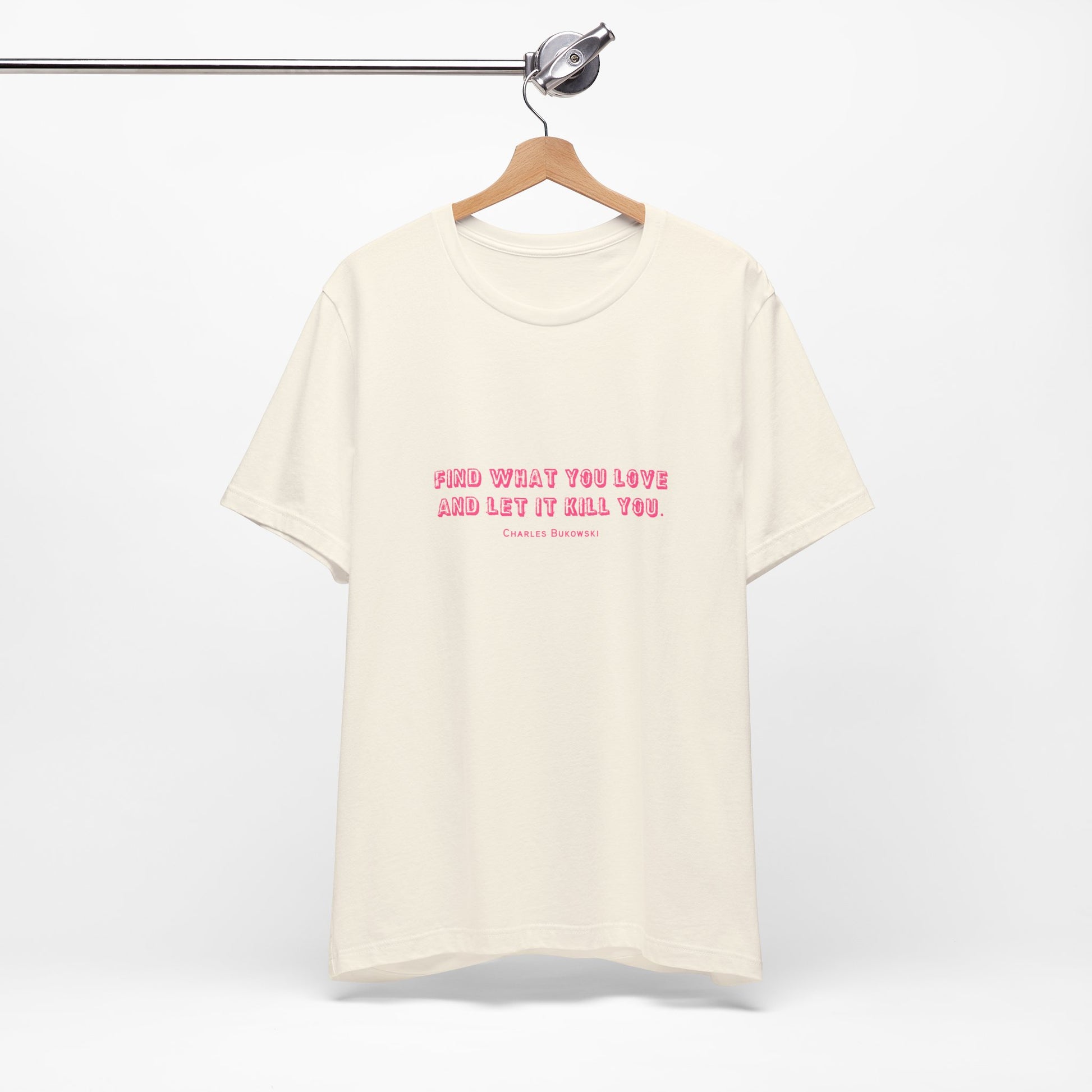 A cream colored Bukowski quote t-shirt hanging