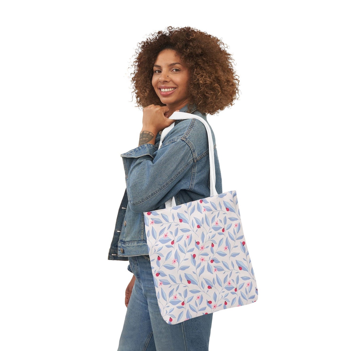 Woman smiling while carrying the Lady Bug Garden Tote Bag on her shoulder.