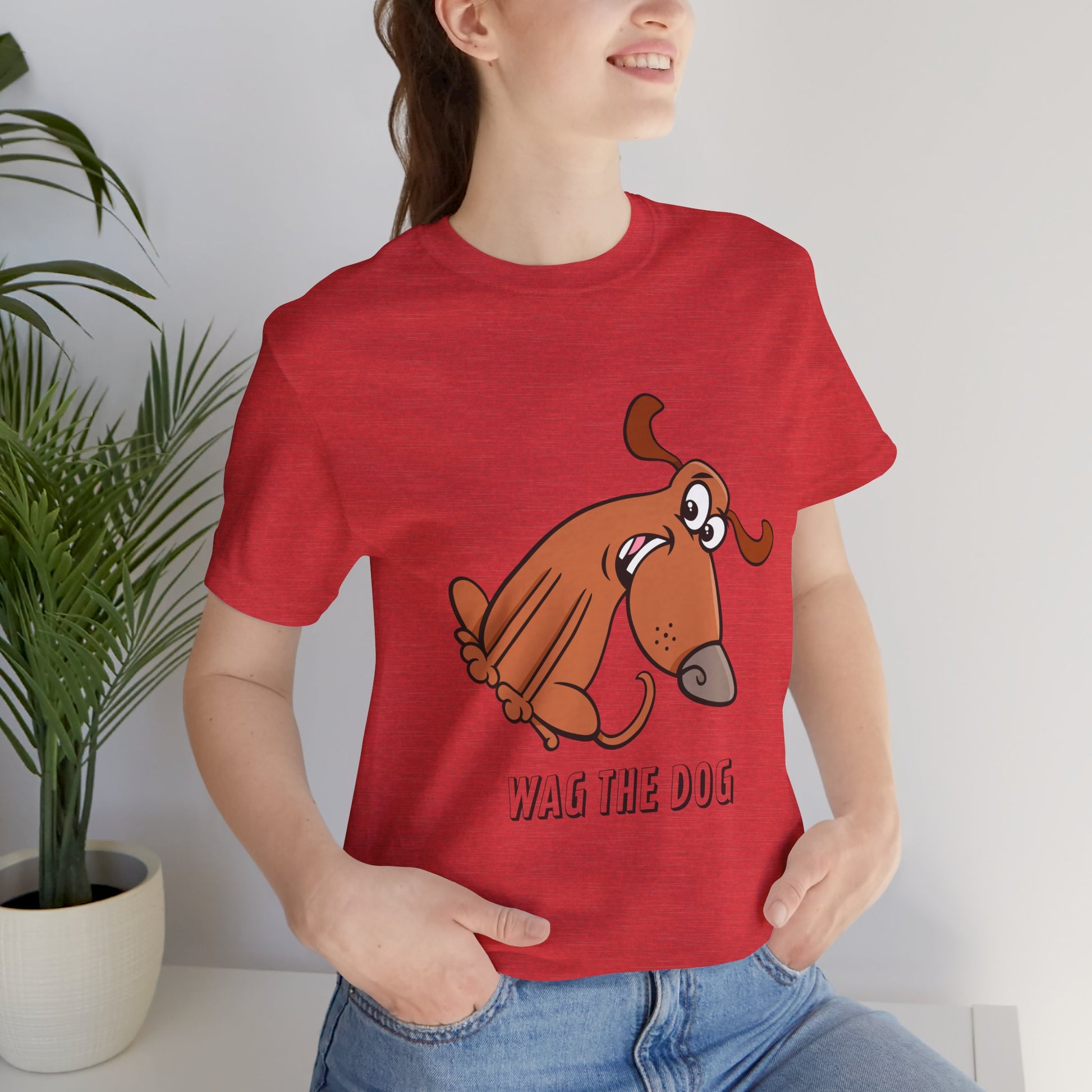 Female model wearing Wag The Dog T-Shirt in red with dog illustration