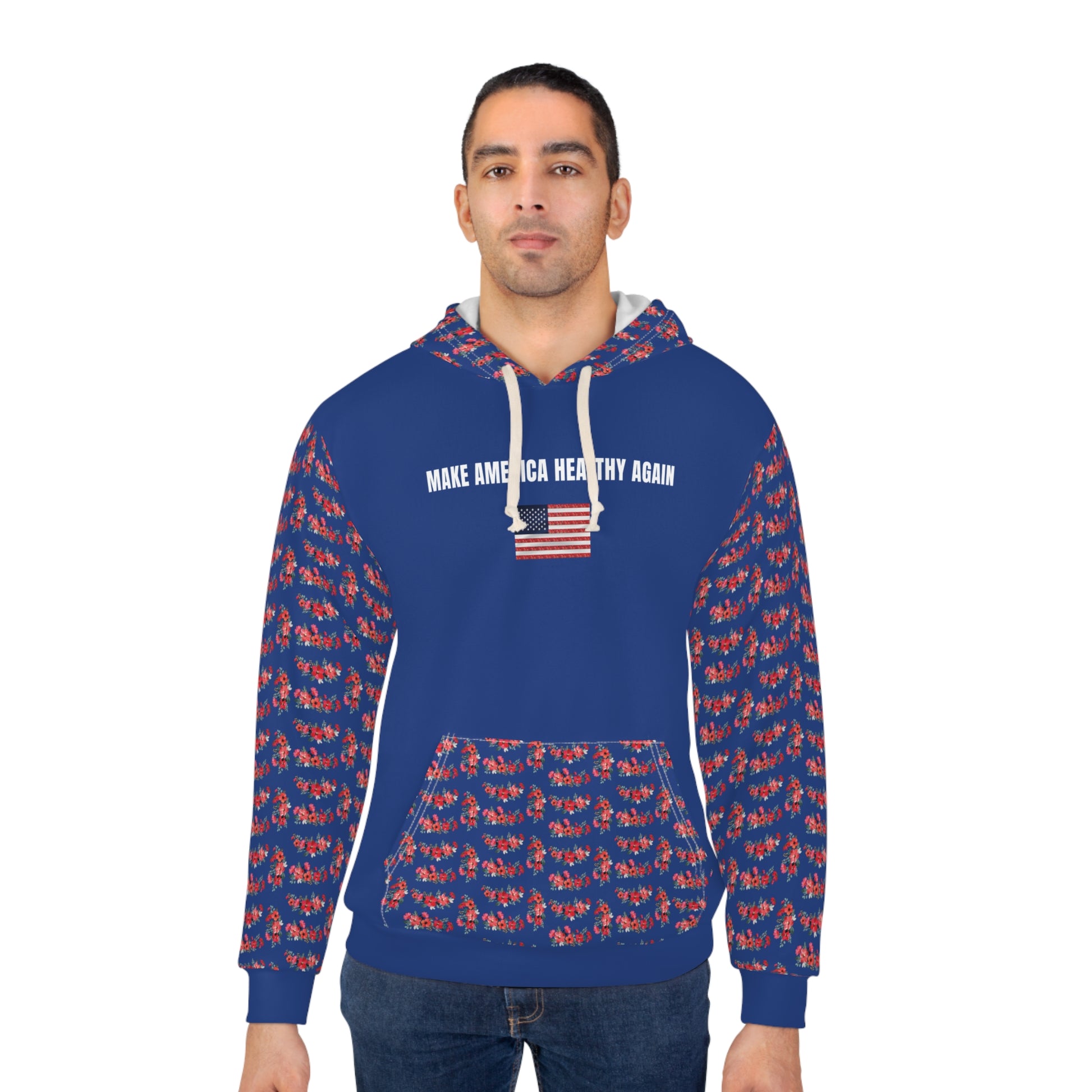 A person wearing a royal blue unisex hoodie that reads "Make America Healthy Again" with an American flag graphic, featuring red floral patterned sleeves and front pocket, standing against a white background.