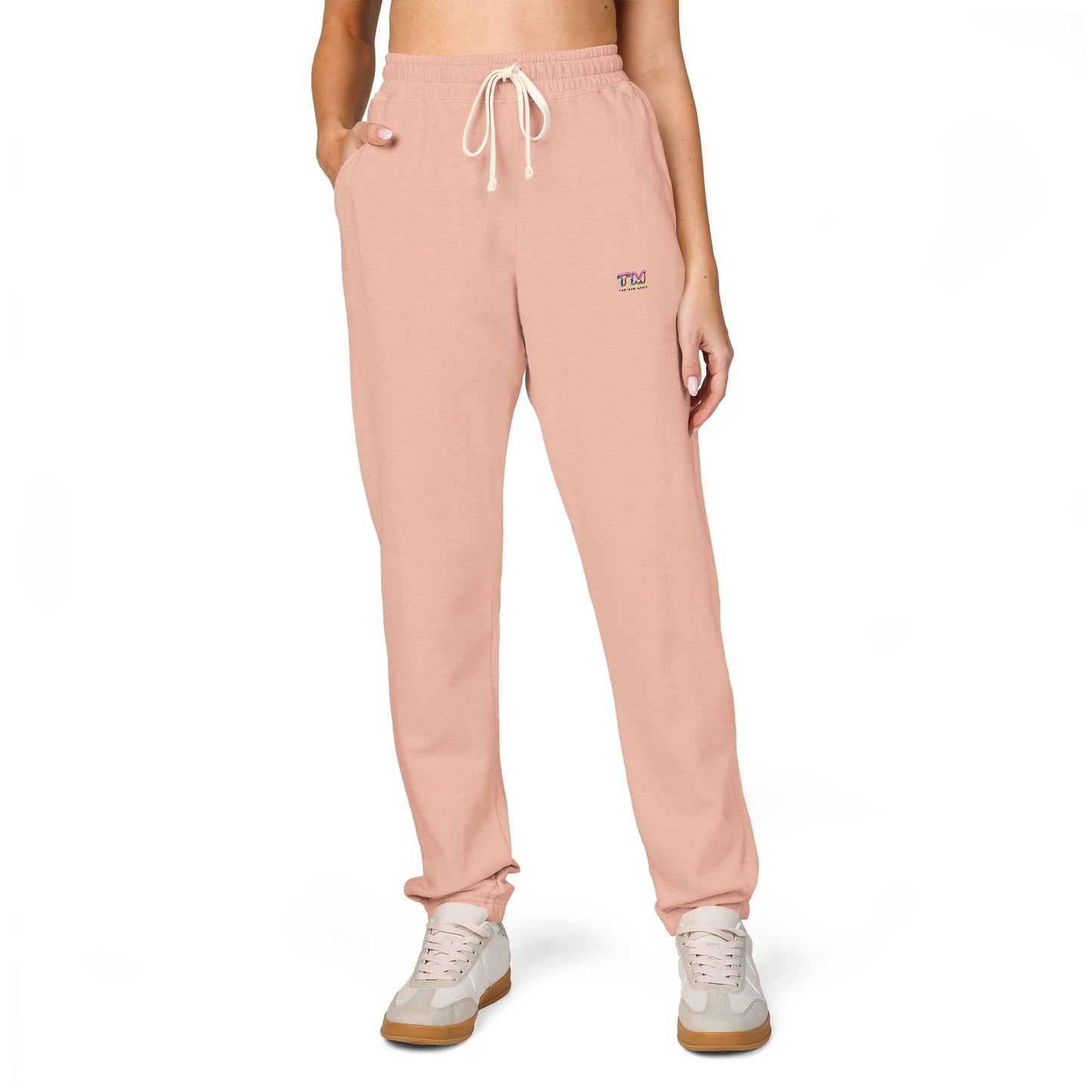 Woman wearing light pink Tantrum Media Sweatpants with embroidered logo