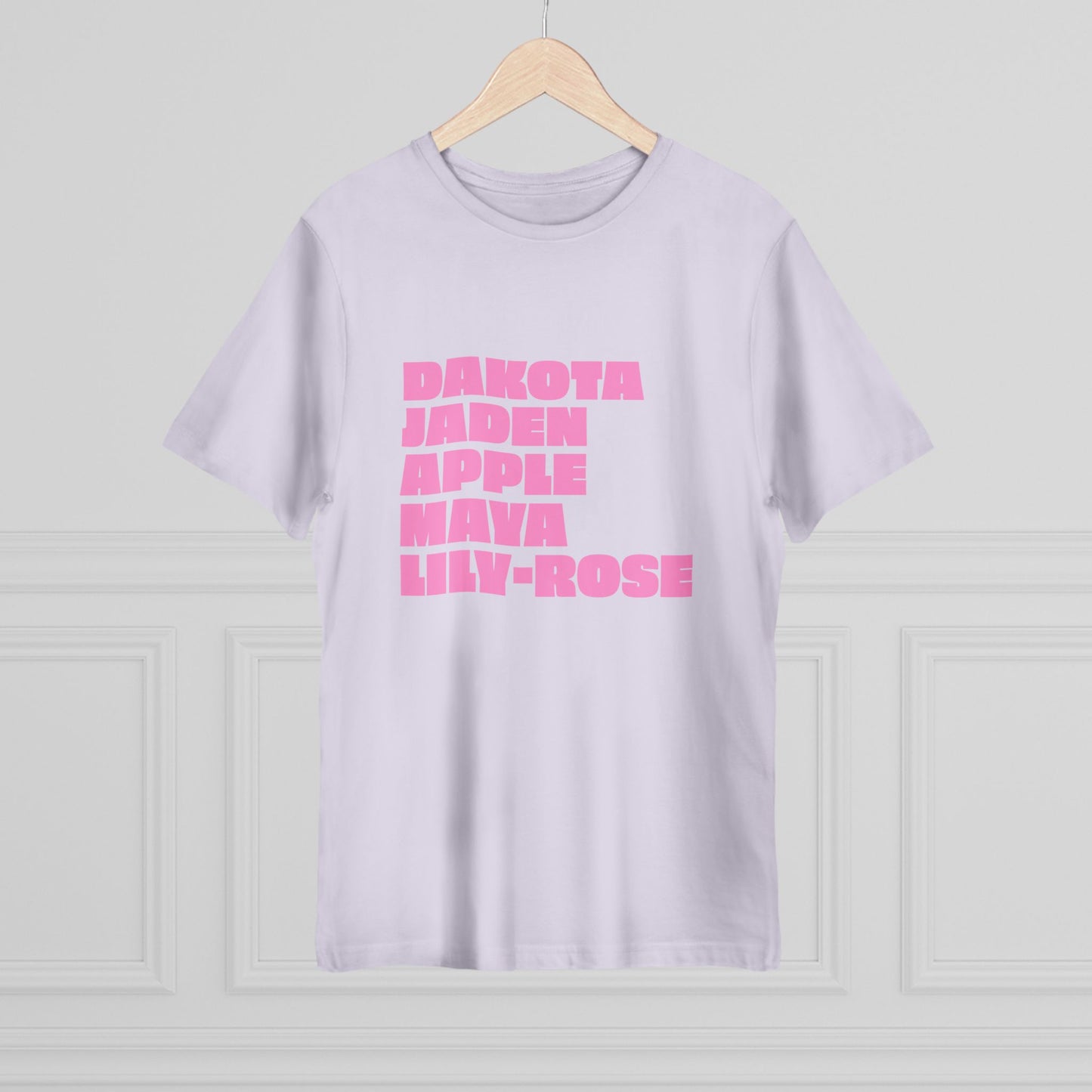 Light purple t-shirt with pink text on a wooden hanger against a light gray background