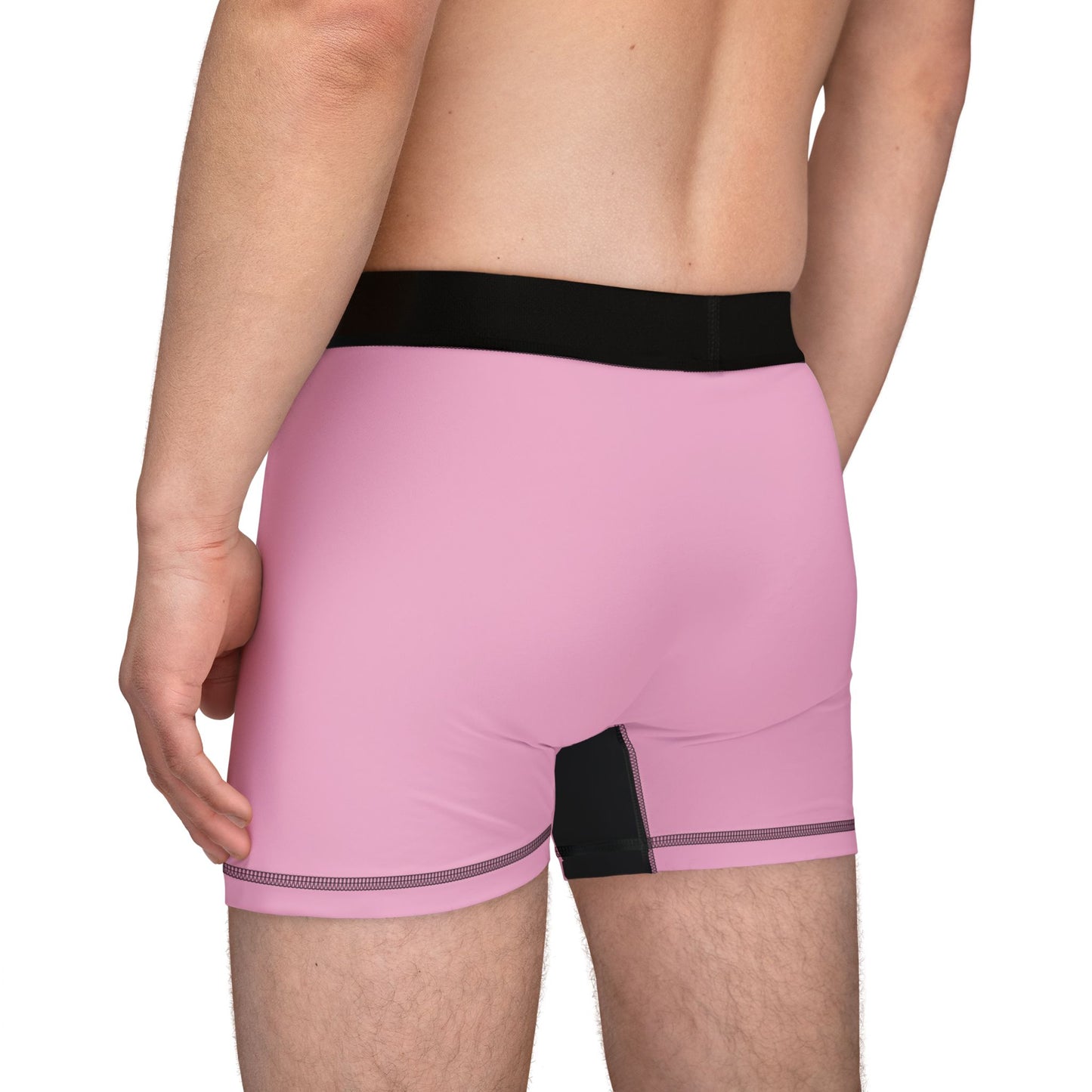 Angled back view of model in Gavin Newsom boxer briefs highlighting pink rear and side seams.