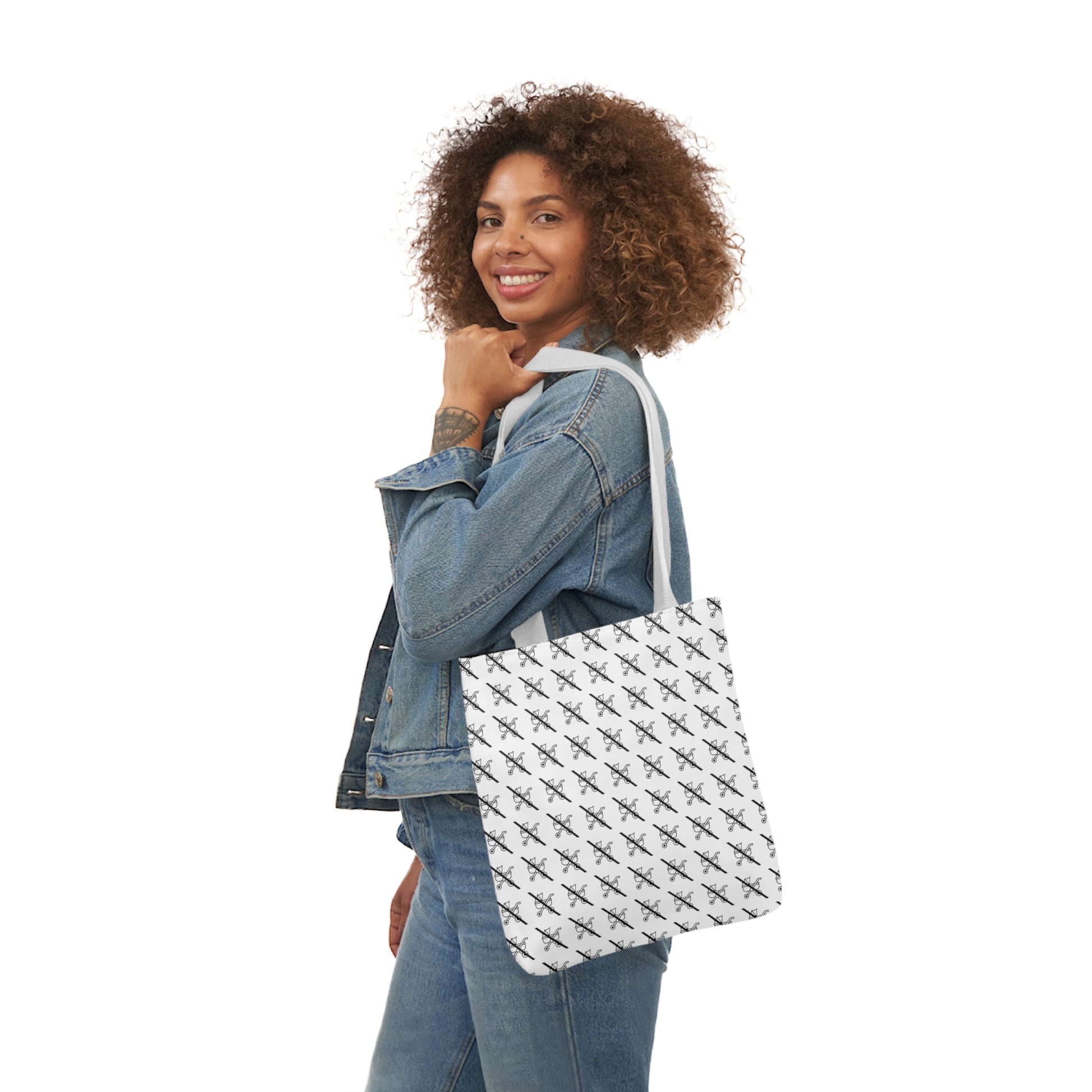 Woman carrying a tote bag featuring a playful "proudly childless" scratched stroller pattern