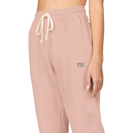 Light pink Tantrum Media Cozy Fleece Sweatpants with side logo and drawstring waist