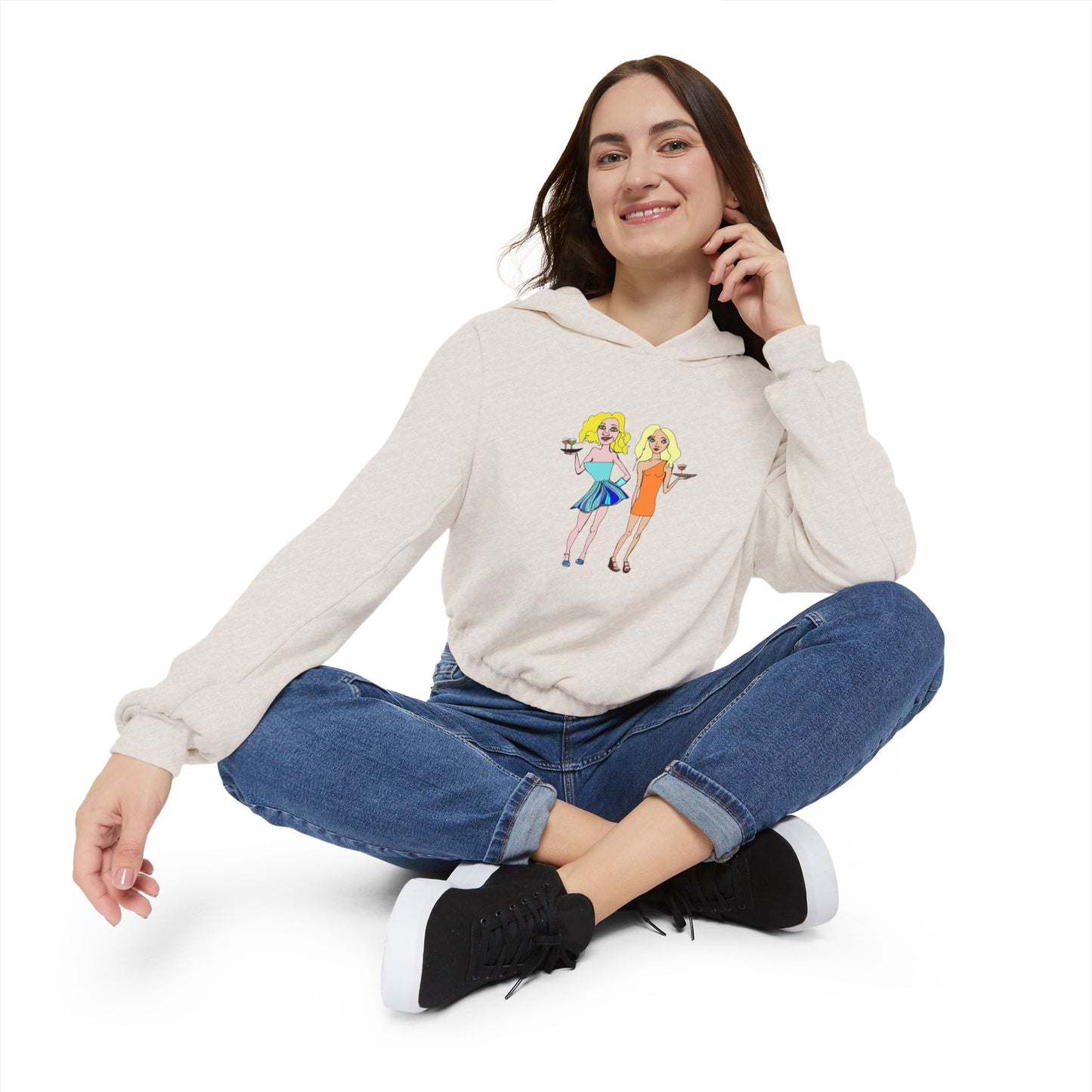 Woman sitting cross-legged in oatmeal hoodie with waitress artwork visible.