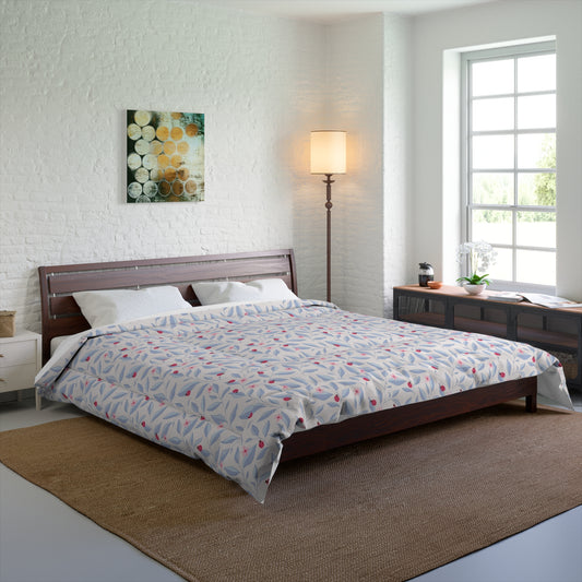 odern bedroom with a wooden bed frame featuring a floral and ladybugs  patterned duvet in soft blue and pink tones, styled with white pillows, a floor lamp, wall art, and natural light from a large window.
